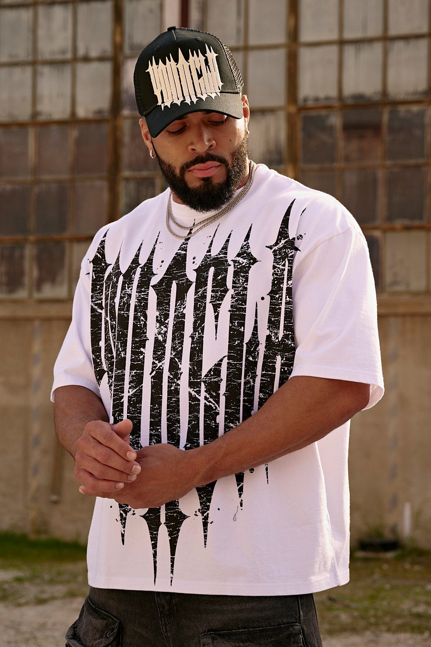 Close-up of distressed gothic graphic on oversized cotton shirt