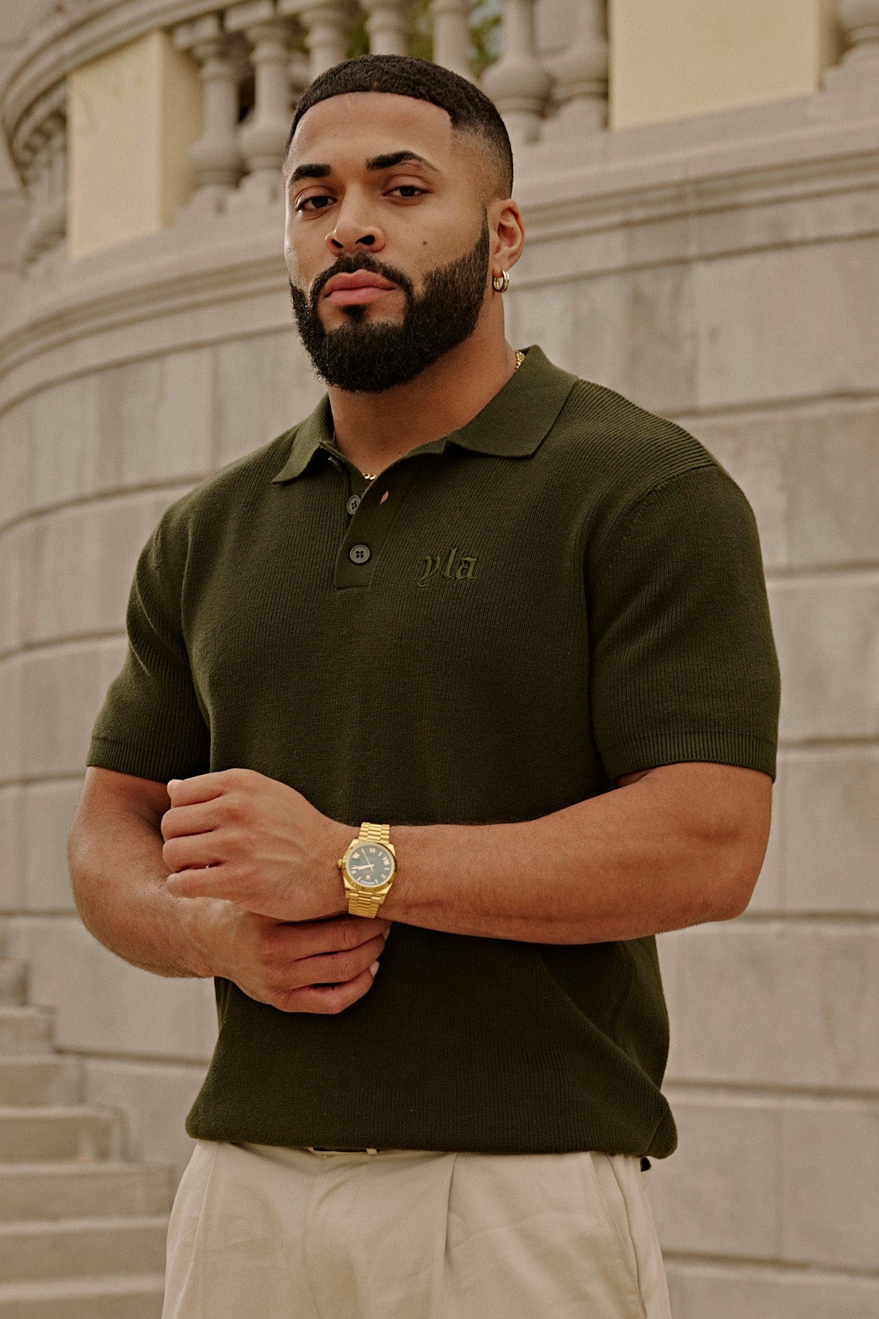 Front view of a fitted knit polo in classic white, ideal for smart casual outings