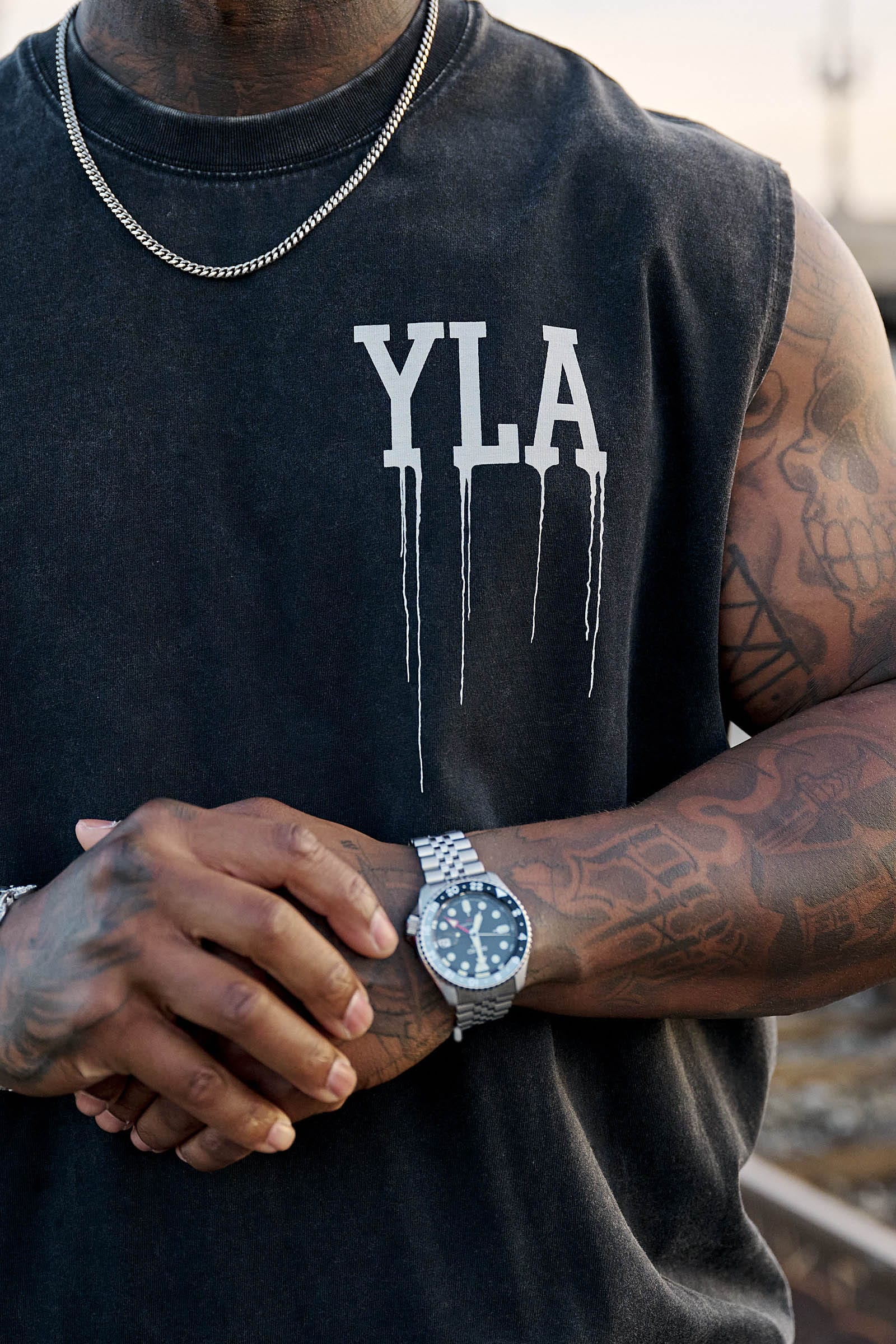 Front view of the drip muscle tank highlighting the logo and relaxed fit