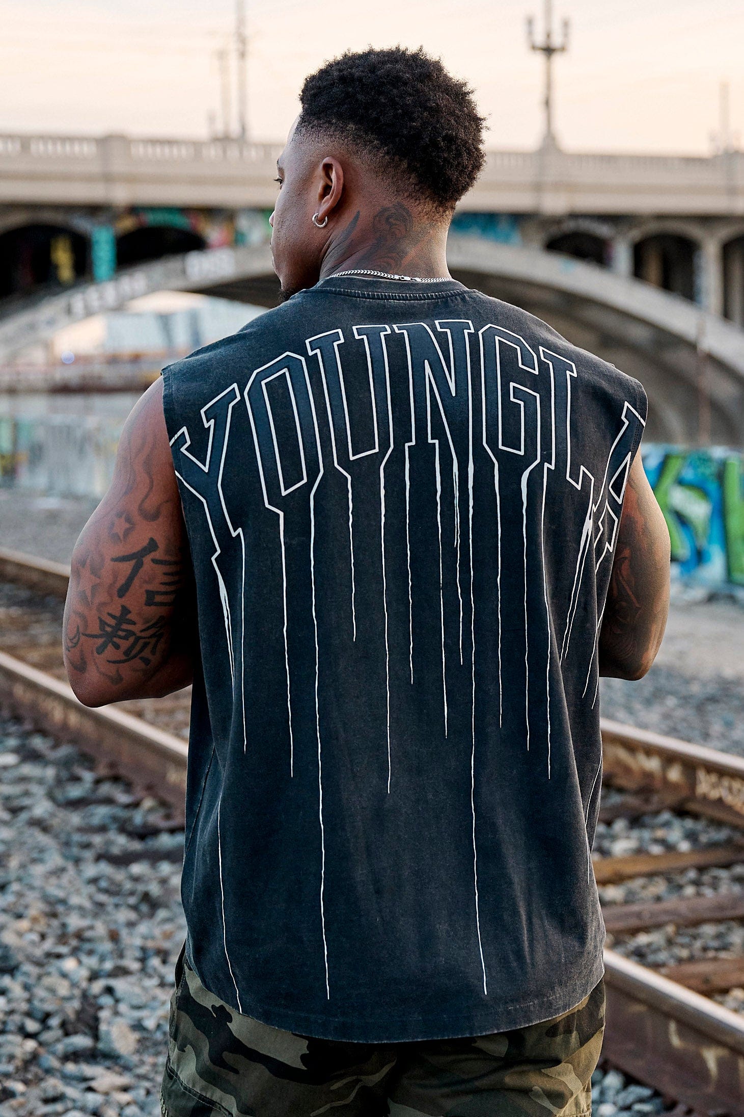 Front view of the drip muscle tank highlighting the logo and relaxed fit