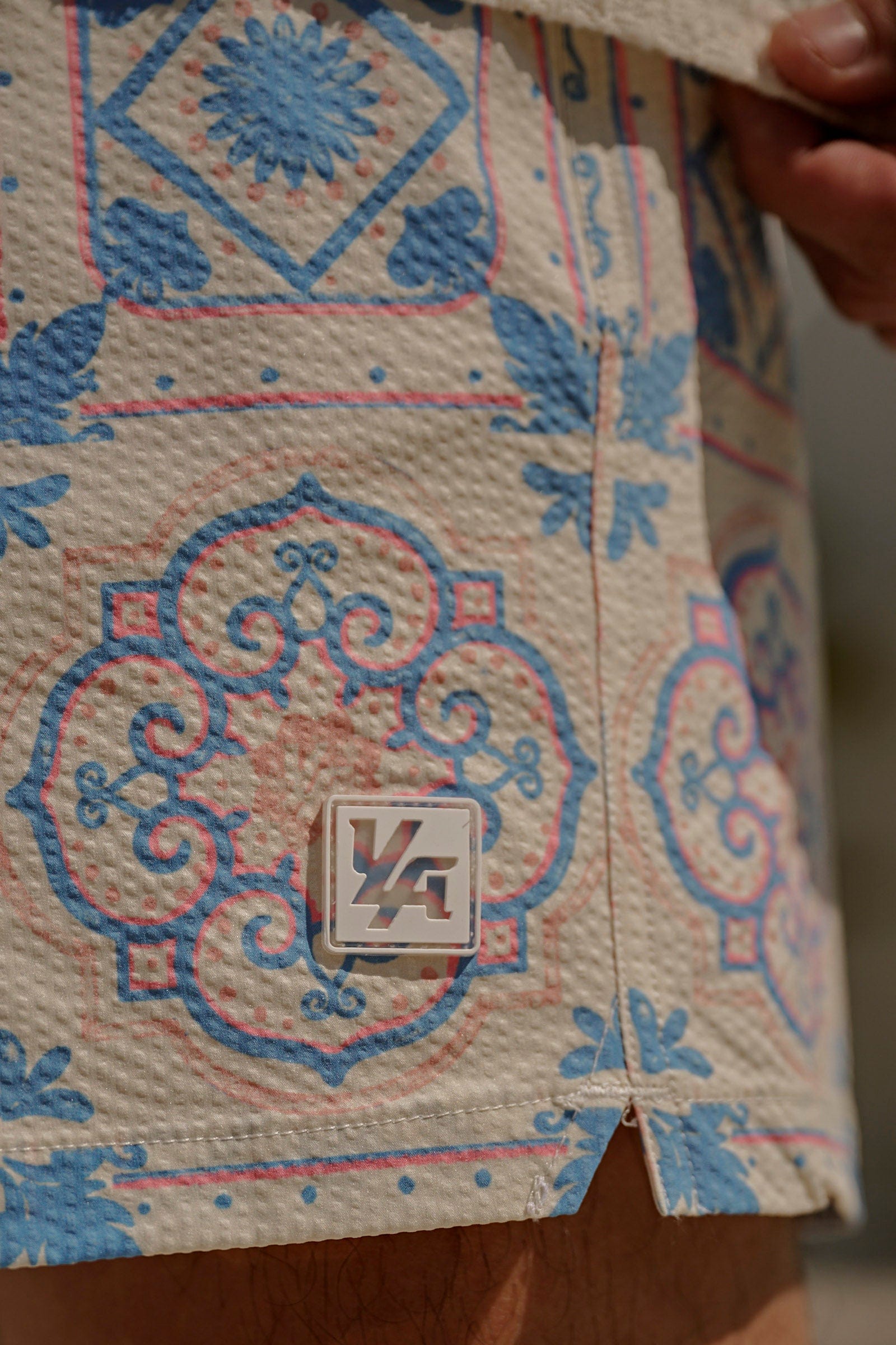 Front view of mosaic swim shorts styled for California beaches