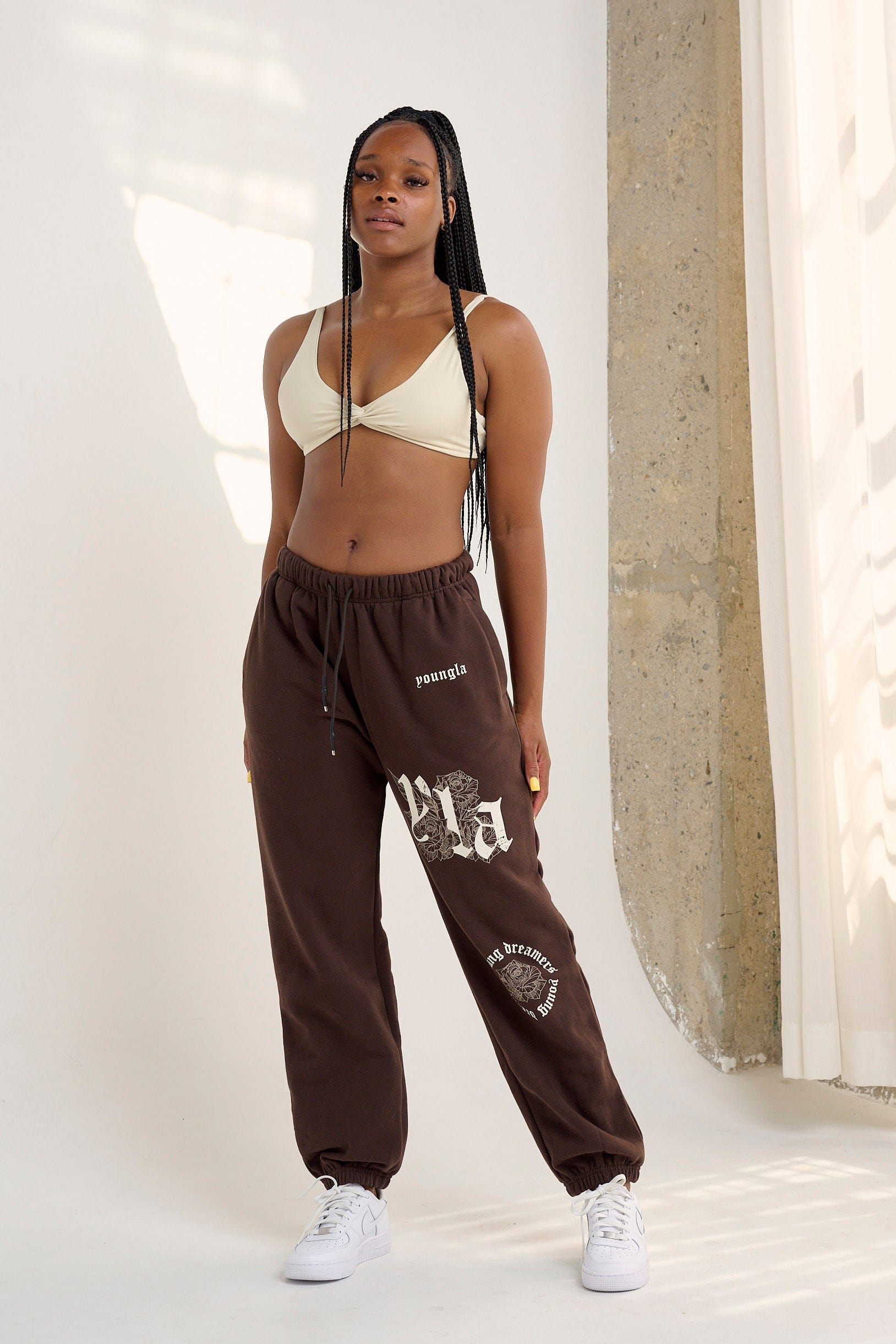 Close-up of rose print and vintage YLA logo on joggers for women