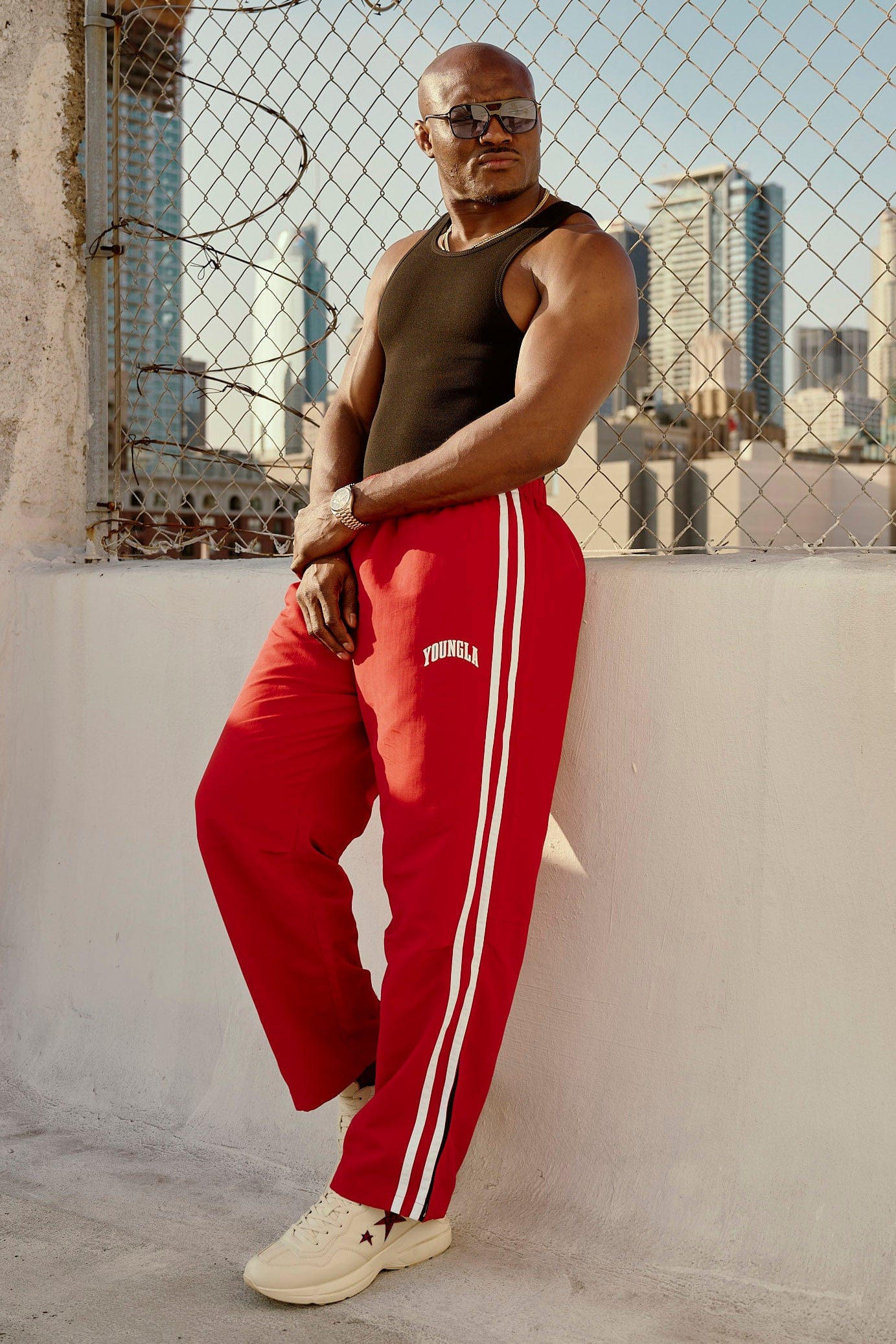 Front view of vintage-inspired track pants showcasing loose fit and side strips.