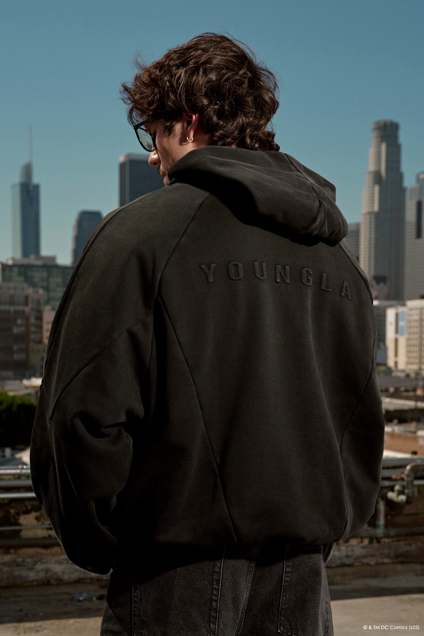 Front view of Superman hoodie for men worn in urban setting.