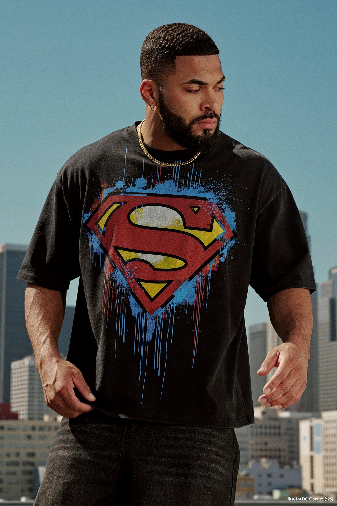 Front view of the black Superman graphic tee on a model.