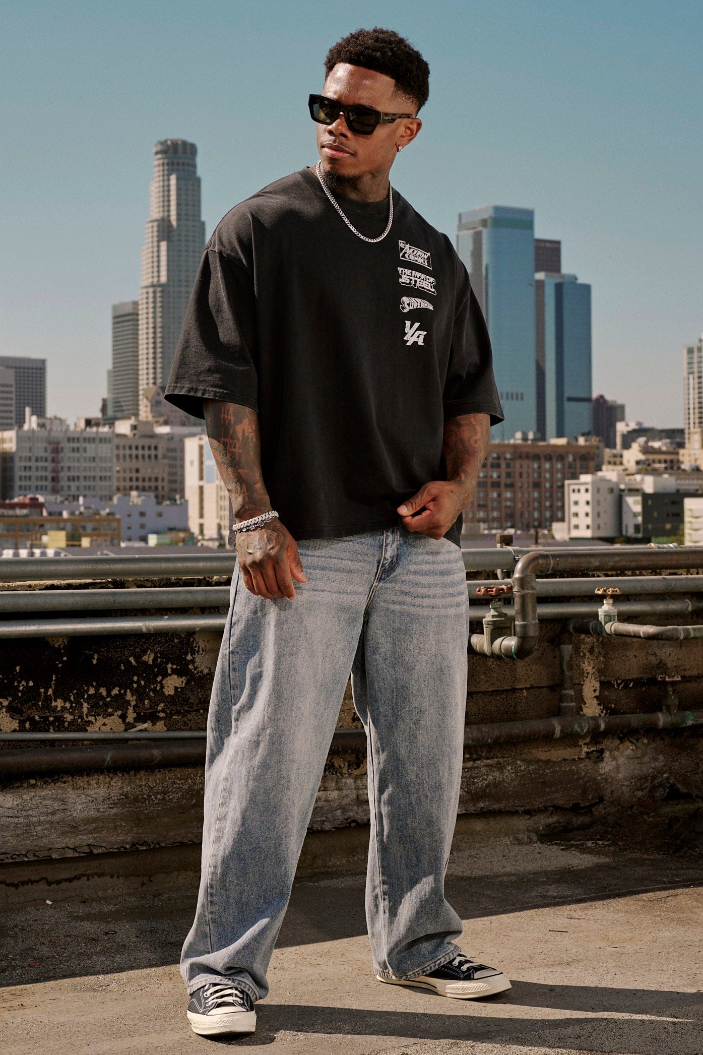 Model wearing the superman logo t shirt showing oversized fit and design details