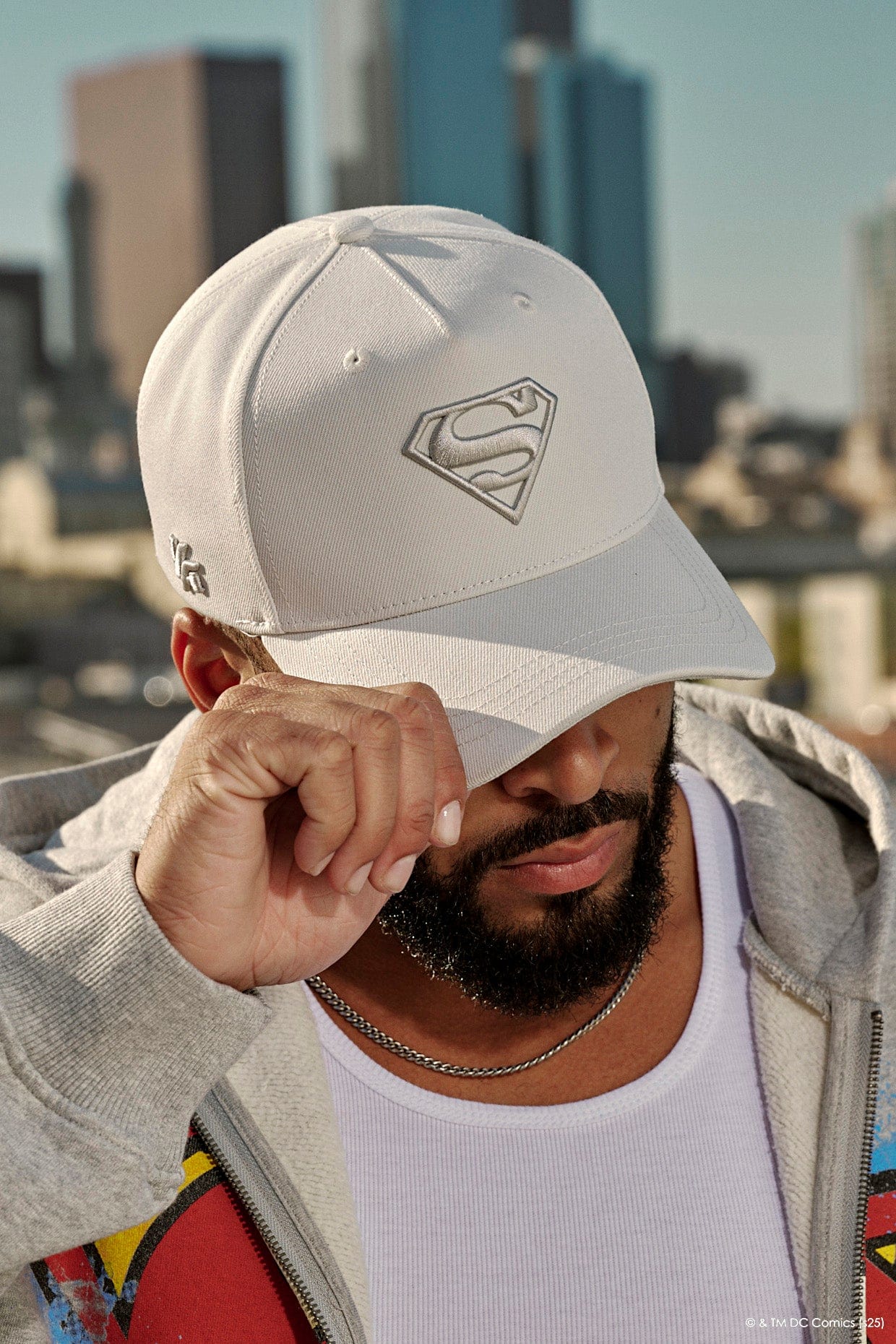 Side profile of custom snapback hats styled with casual streetwear in urban settings.
