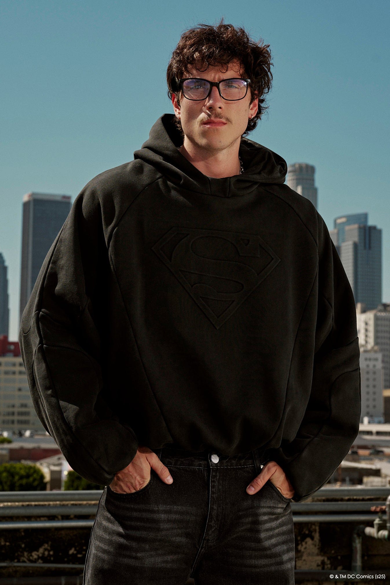 Back angle of superman hoodie zip up highlighting panel cuts and structure.