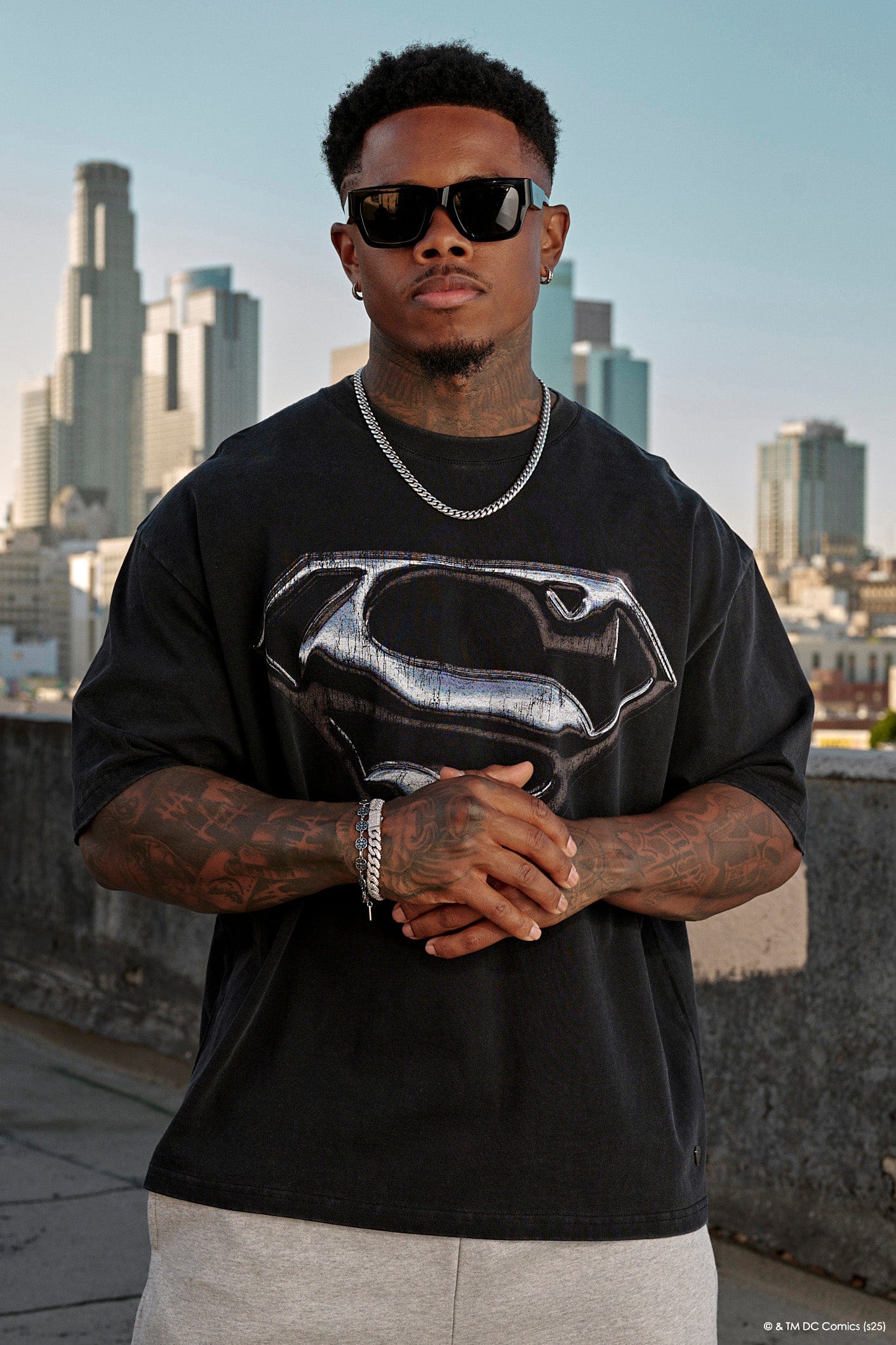 Front view of the black Superman graphic tee on a model.
