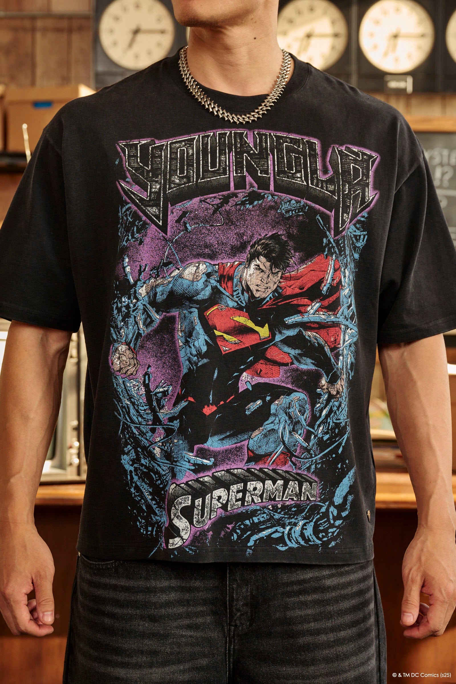 Model wearing the oversized Superman t-shirt in a casual setting.