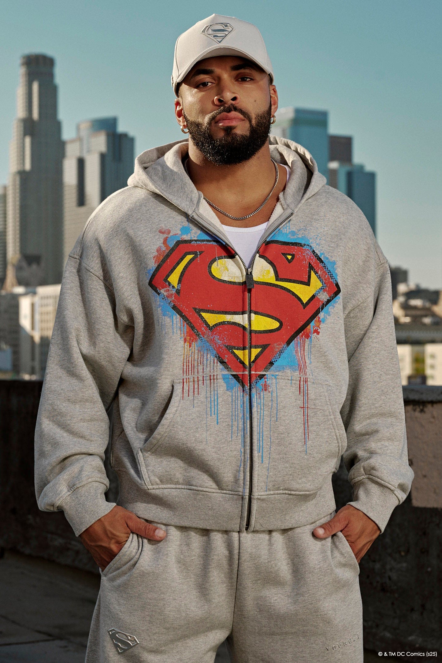 Close-up of the Superman logo on the oversized hoodie, highlighting its vibrant colors.