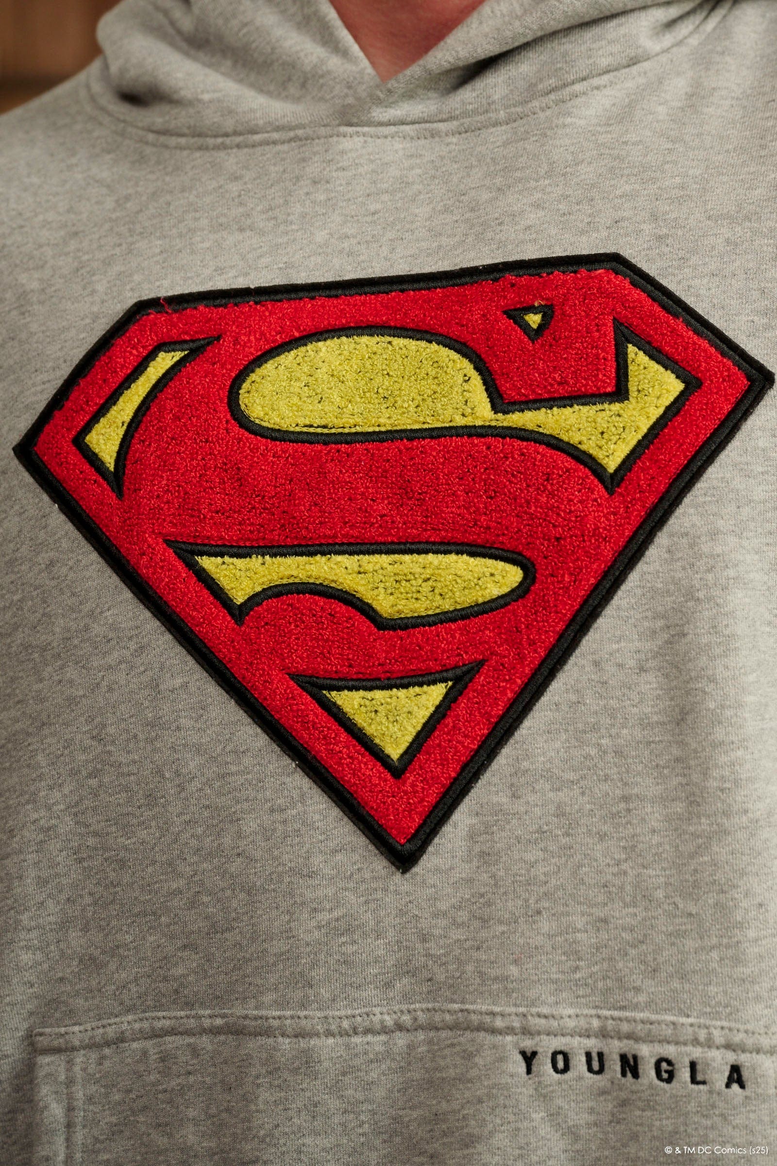 Model wearing the Superman Legacy hoodie in a casual setting.