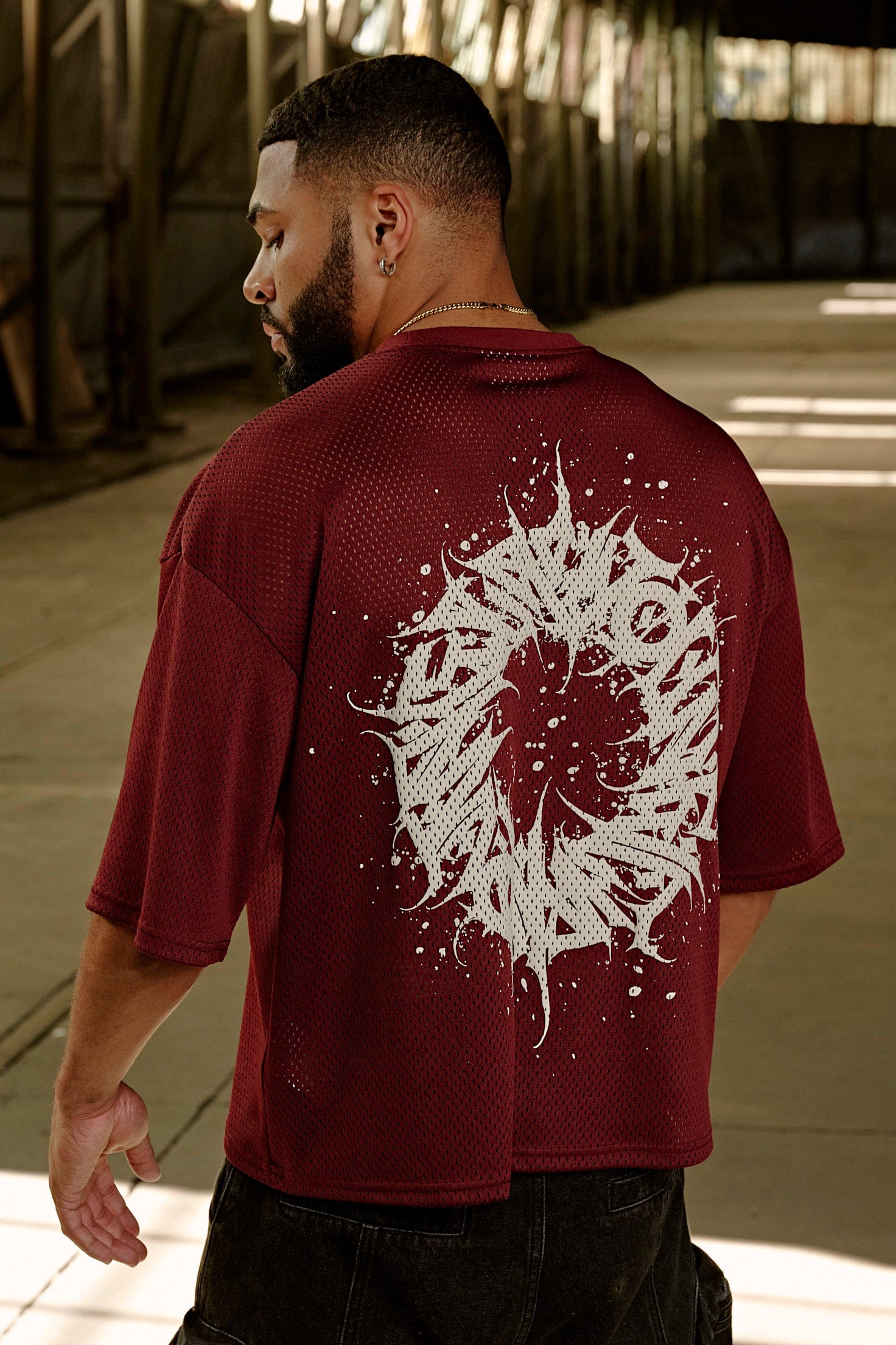 Rear view of mesh football jersey with reflective details.