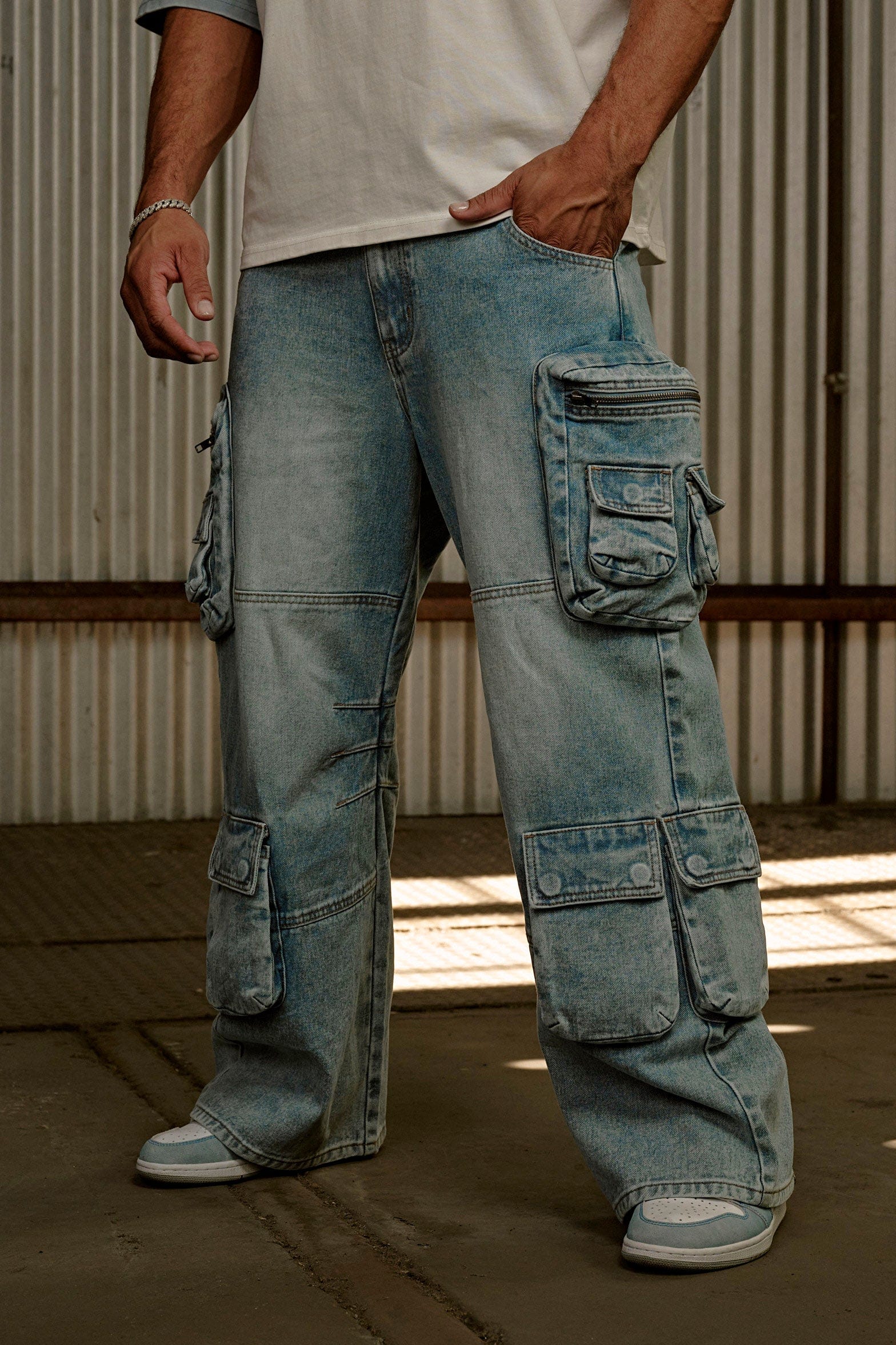 Front view of urban utility stacked jeans for men with cargo pockets.
