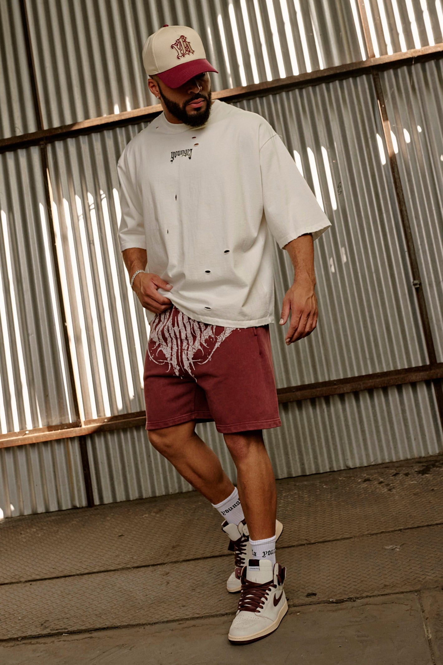 Side view of model wearing oversized t shirt men version with ripped detailing