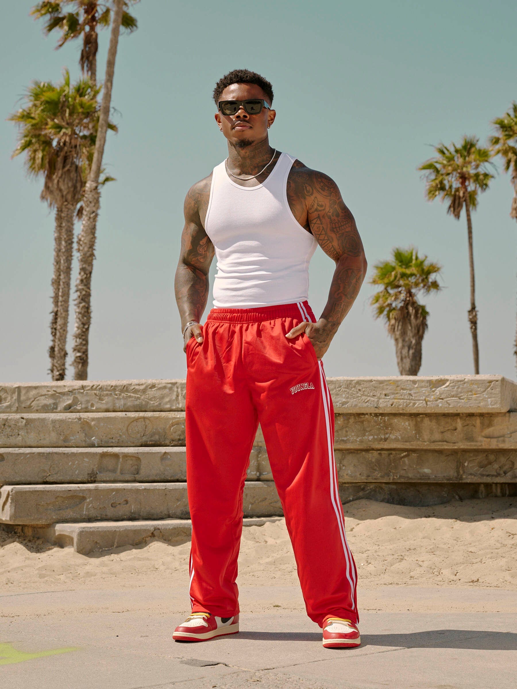 Track pants women edition in a retro clothing ensemble near the beach