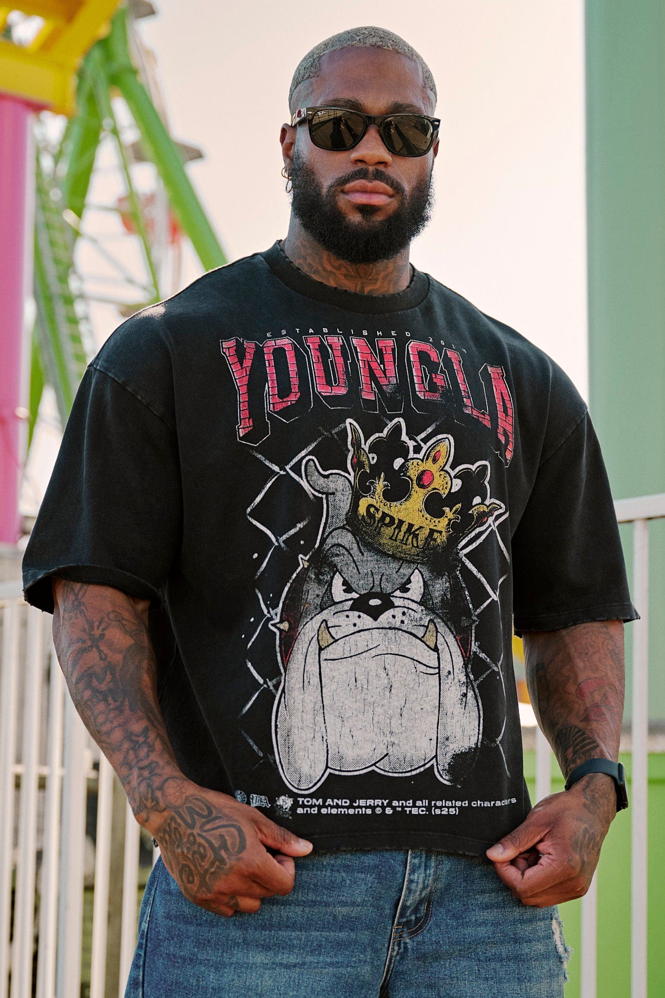 Model wearing oversized T shirt with nostalgic Tom & Jerry design in casual setting