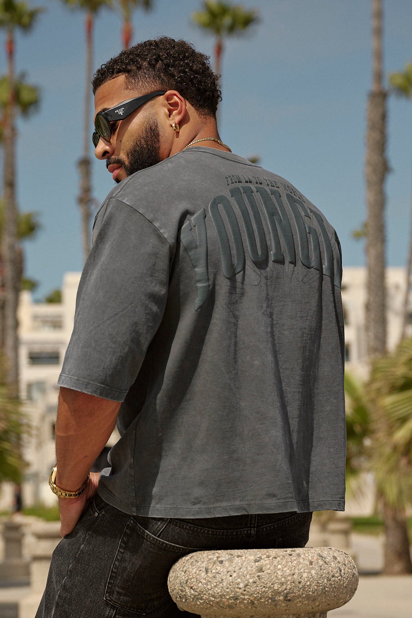Close-up of the boxy cropped tee’s puff print logo on black fabric