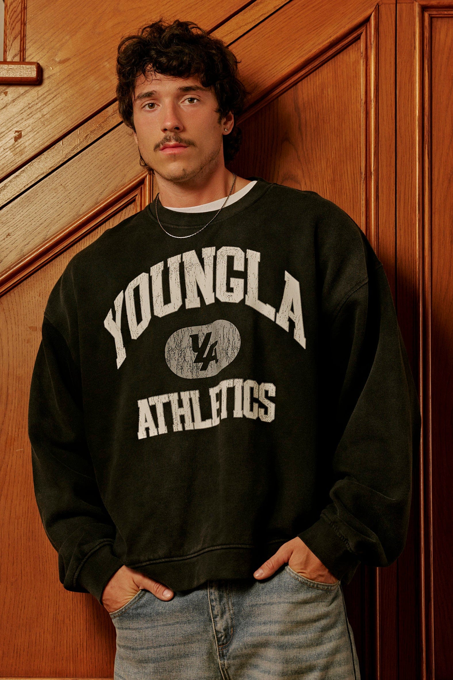 Close-up of camo crewneck neckline and graphic detailing on heavyweight fabric