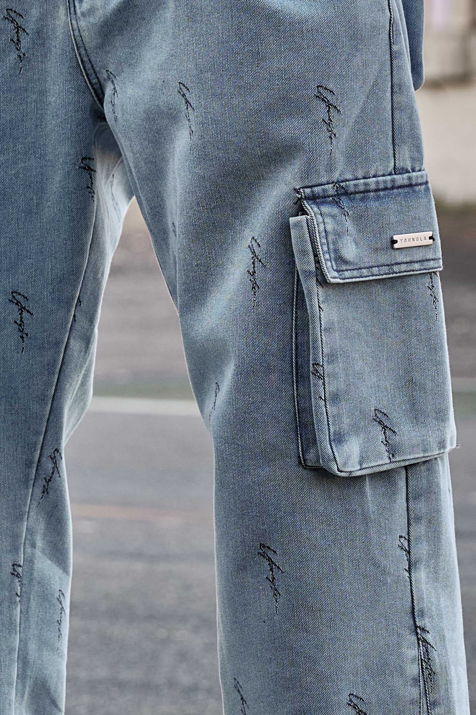 Close-up of cargo trouser jeans detailing metal tag and jacquard pattern