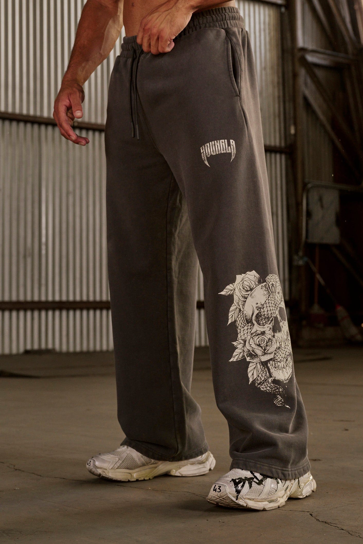 Model wearing baggy joggers in a casual setting.
