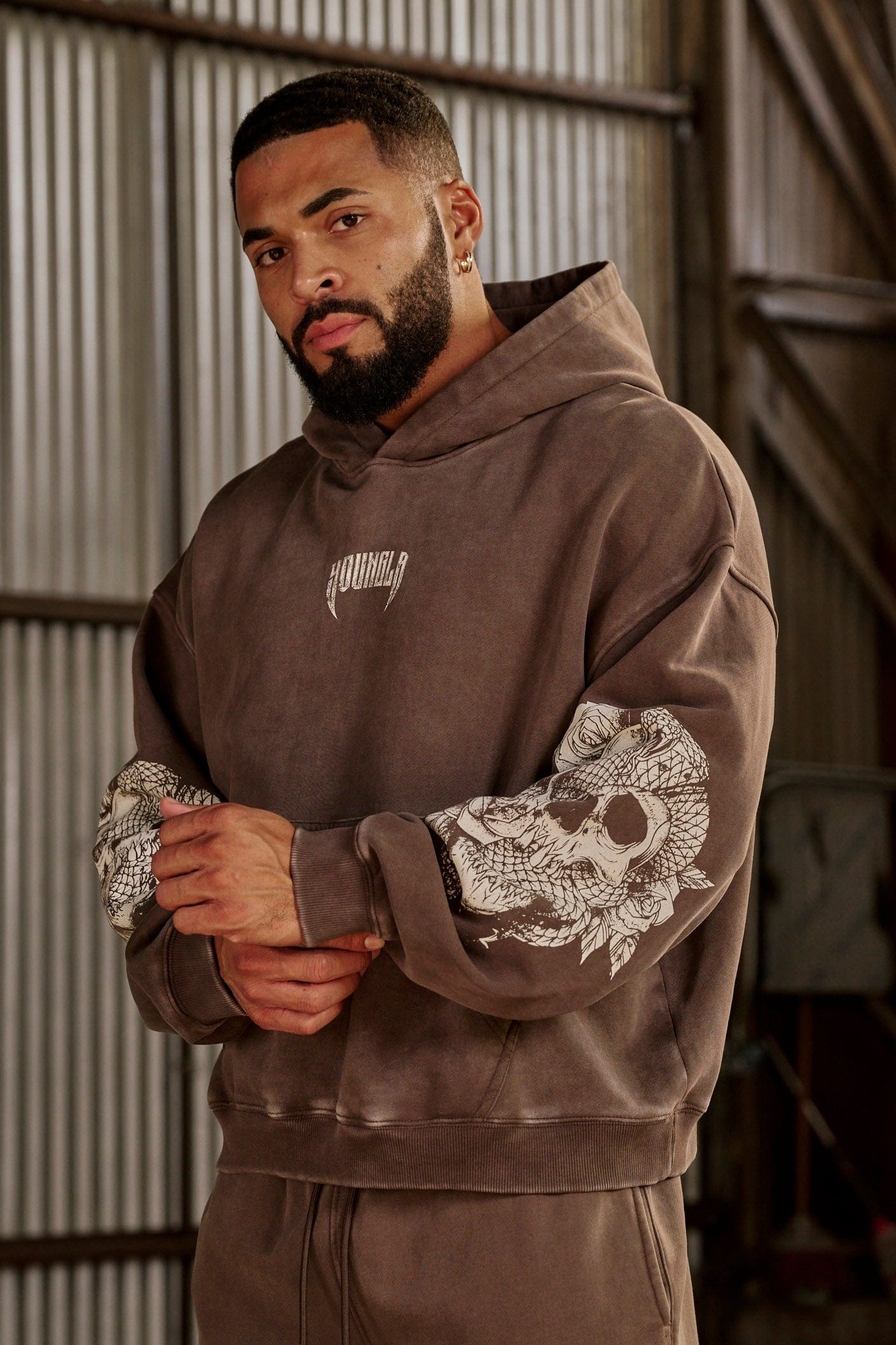 Side angle showing womens oversized hoodie fit and embroidered chest logo detail