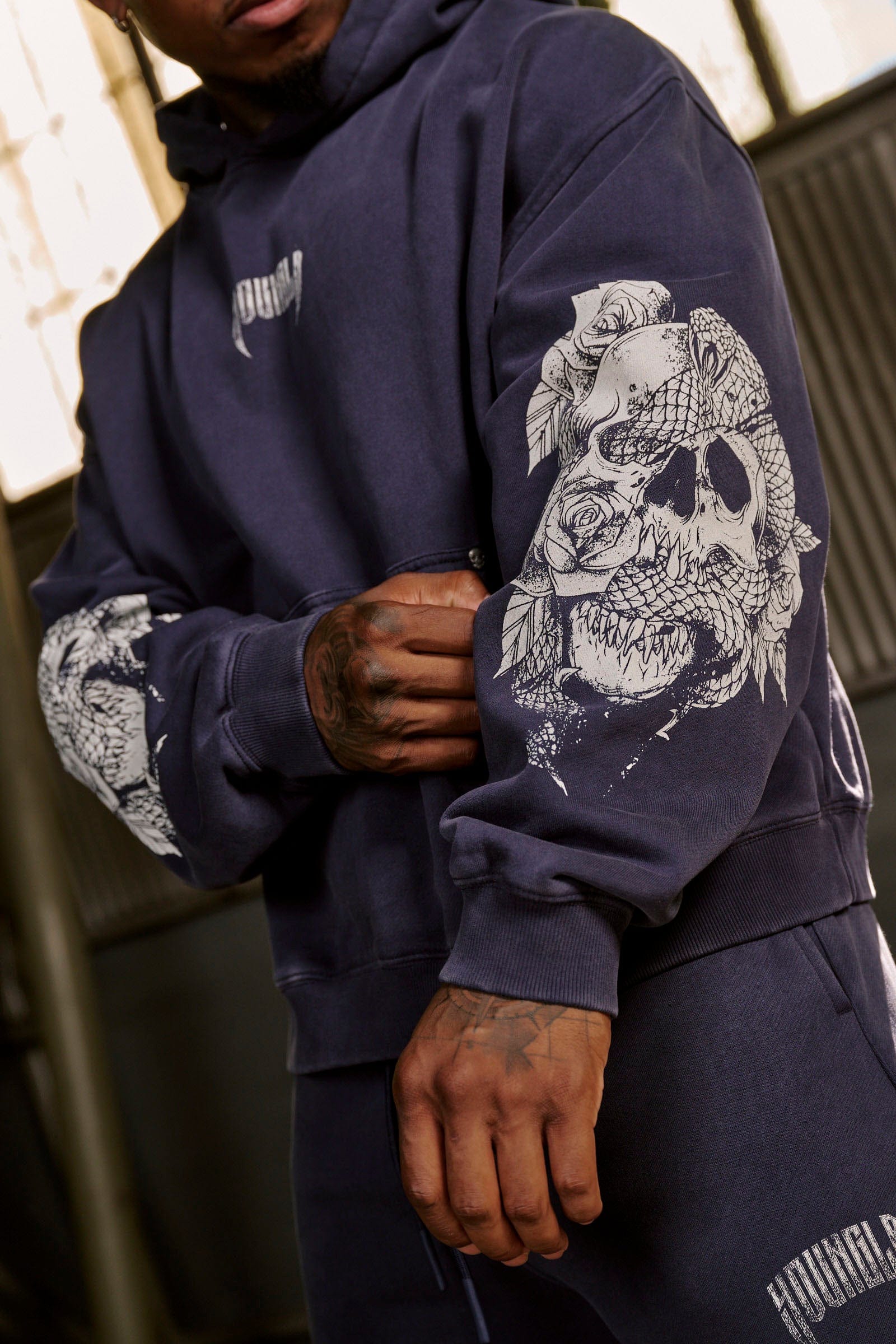 Front view of oversized hoodie men style with skull sleeve design, perfect for fall layering