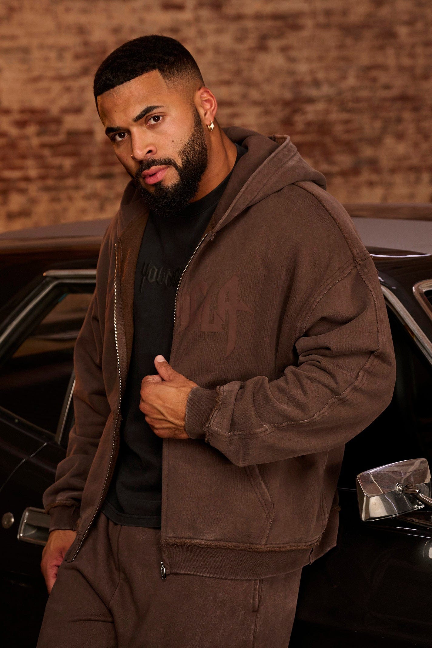 Rear view of comfort hoodie layered over a cotton tee, perfect for travel.