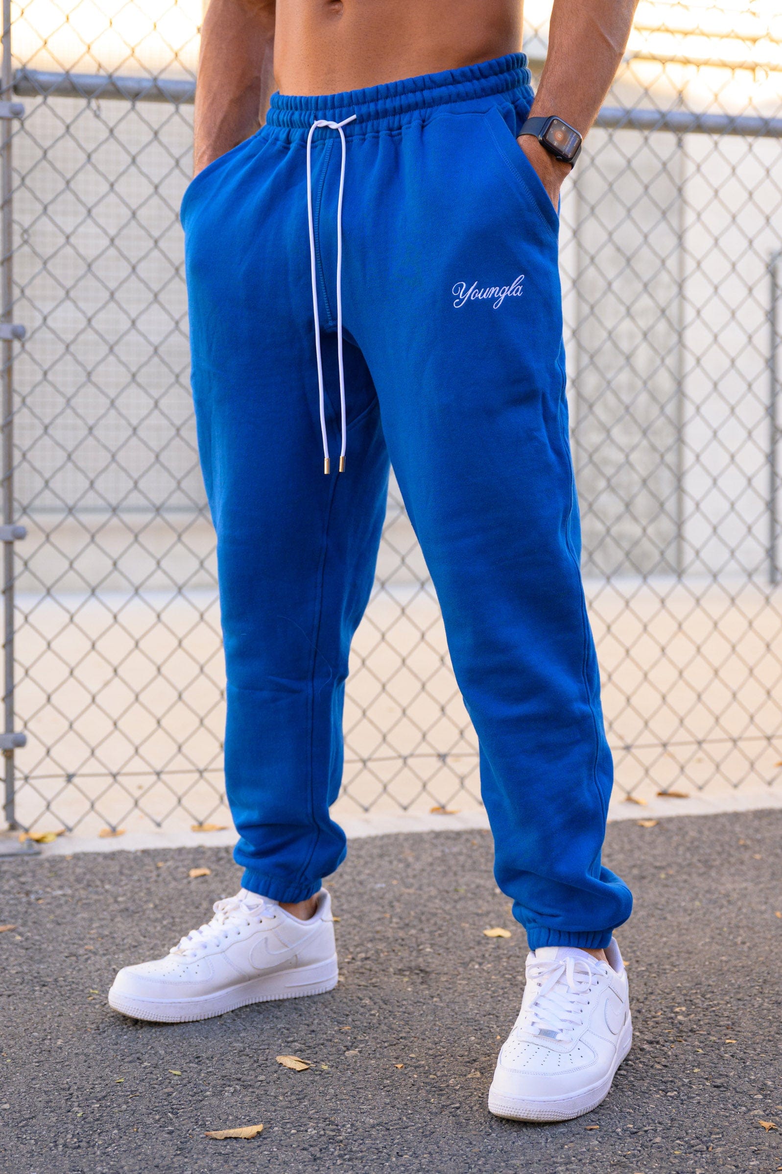 Side profile of model wearing loose-fit joggers in urban setting