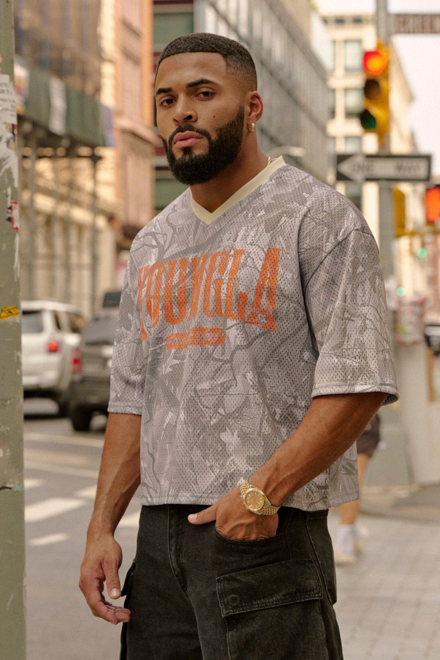 Front view of varsity football cropped jersey with ribbed V-neck and distressed logo