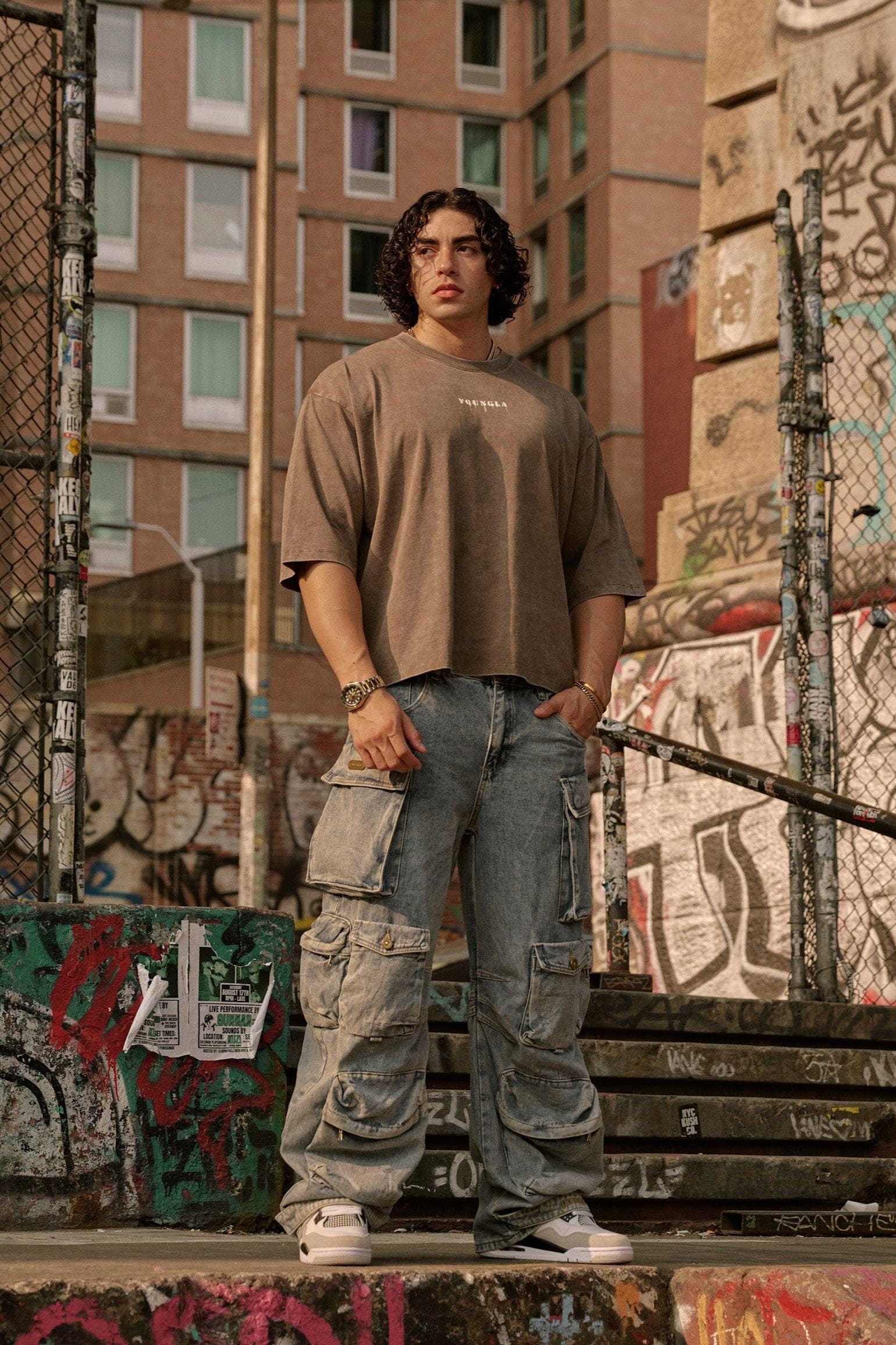 Model wearing loose fit cotton t-shirt with cropped length and minimalist logo