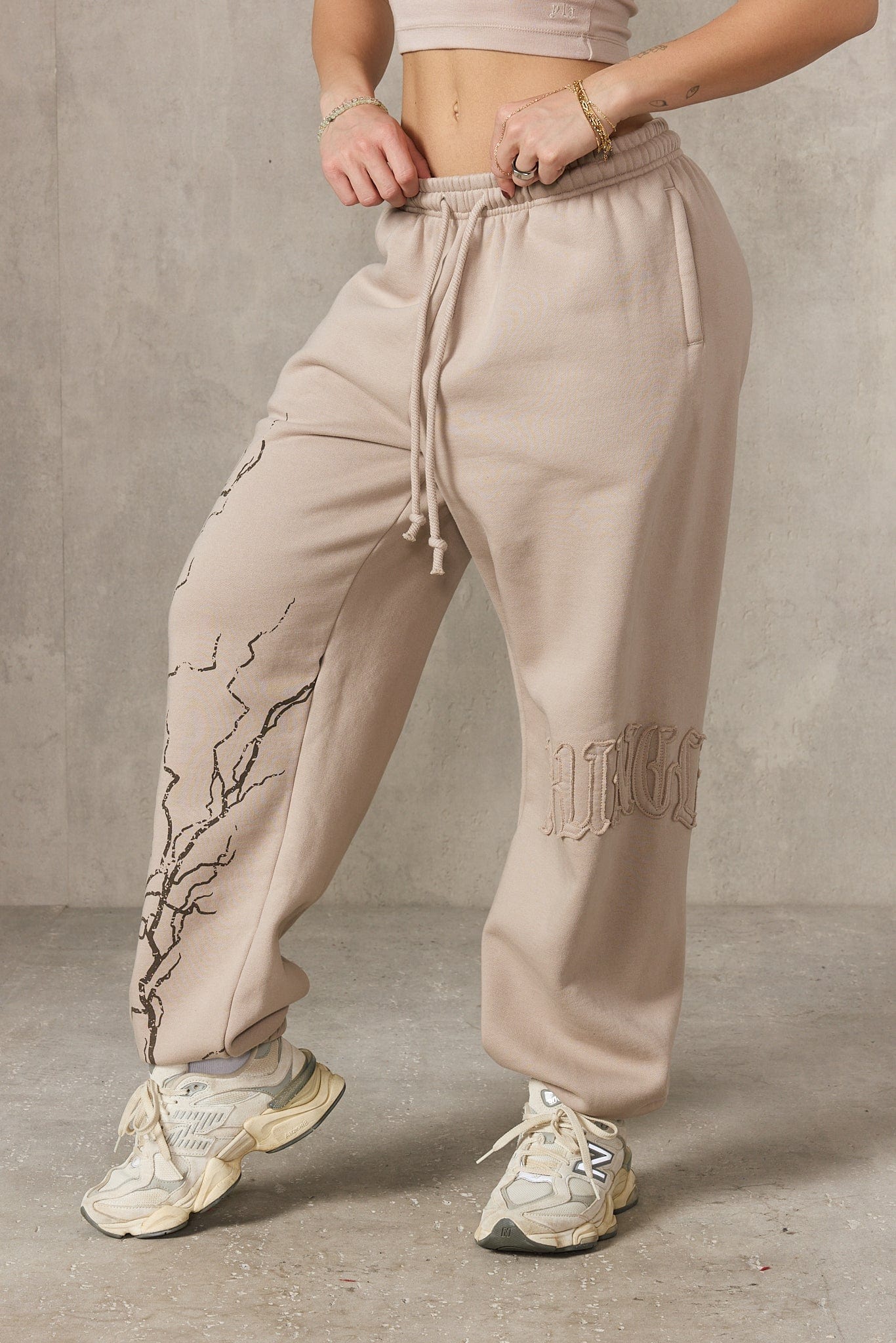 Model wearing joggers paired with a matching hoodie.