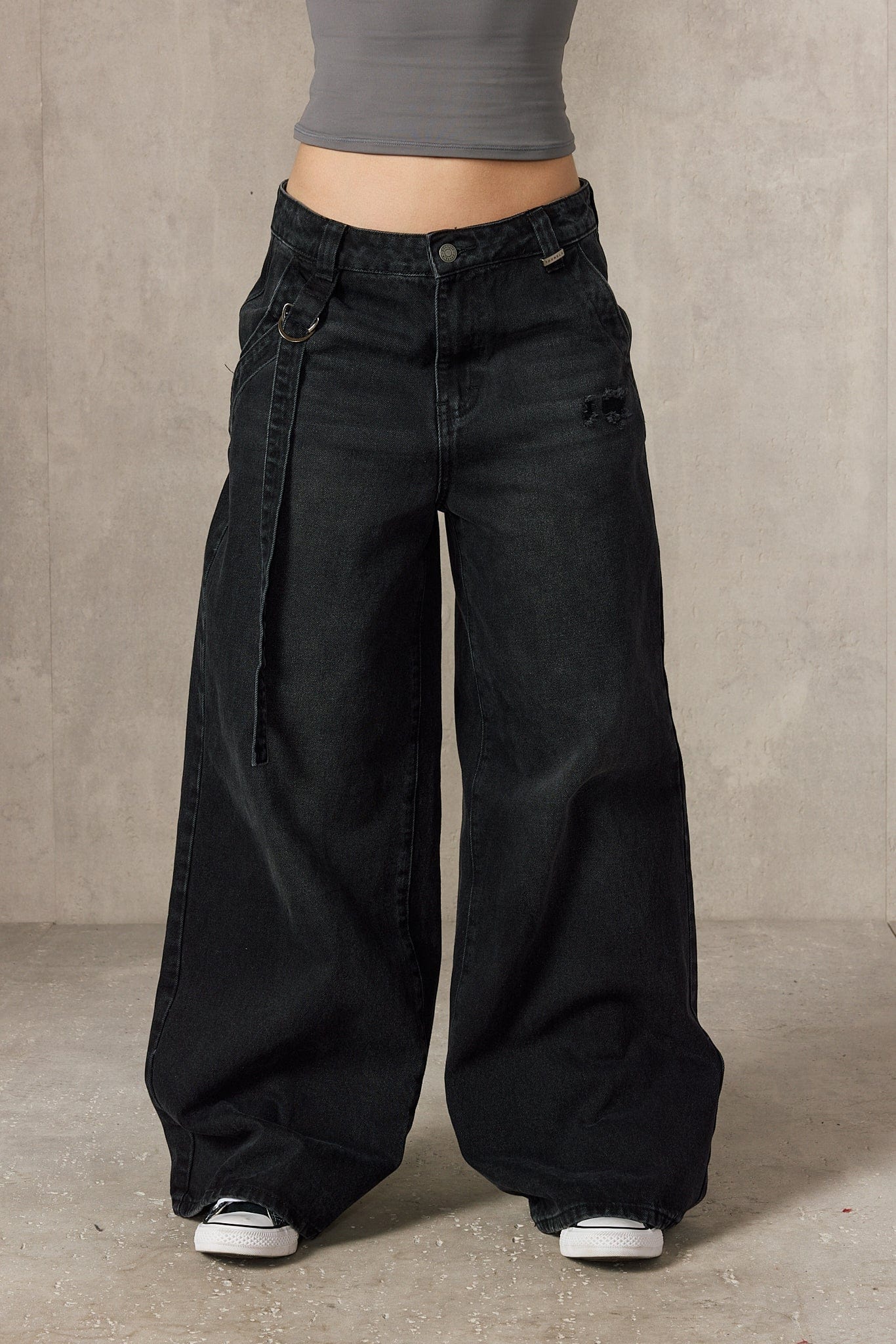 Close-up of the jeans fabric highlighting the buckle details.