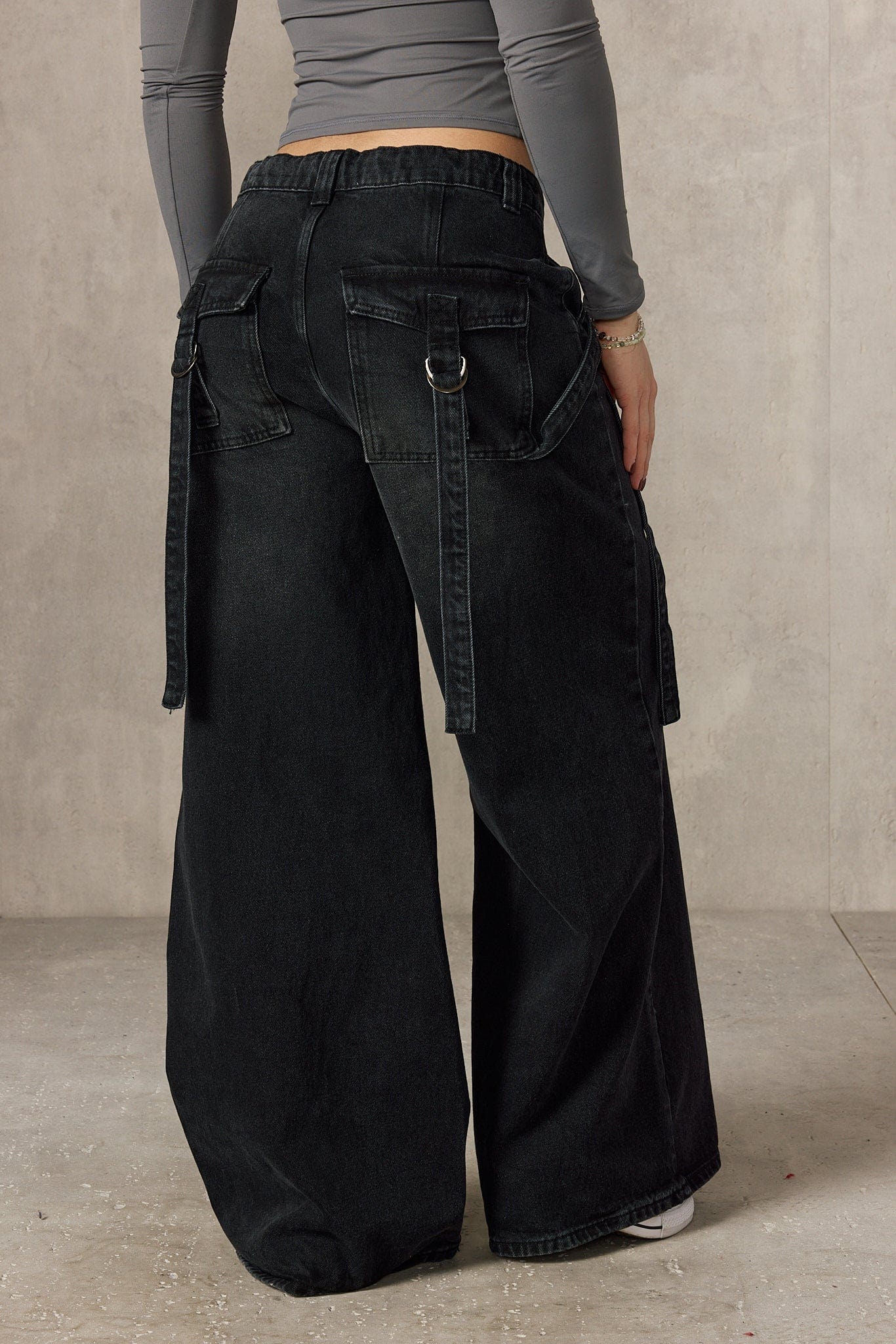 Side angle of the impact jeans showcasing the unique buckle design.