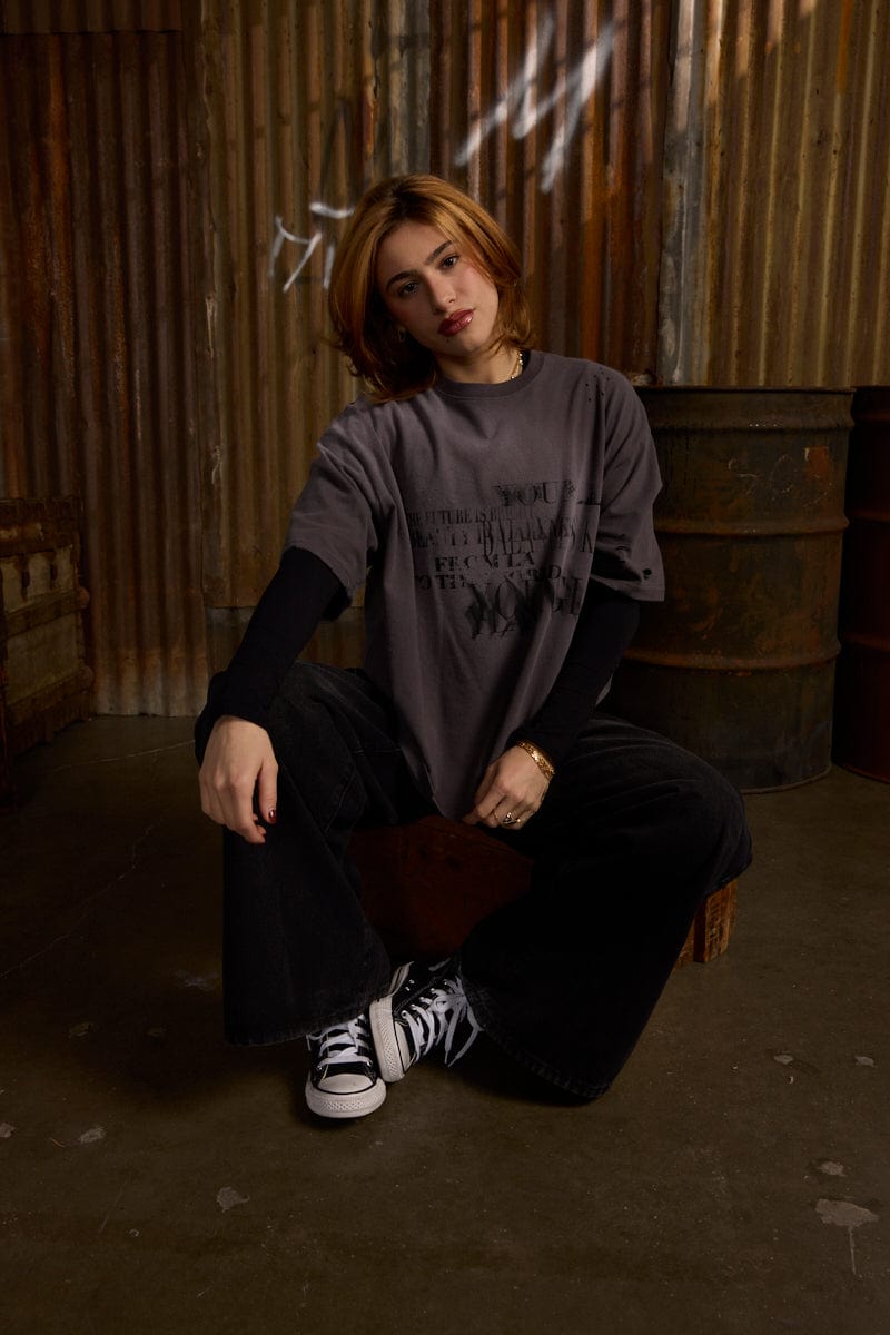 Close-up of illusion graphic print on oversized black tee