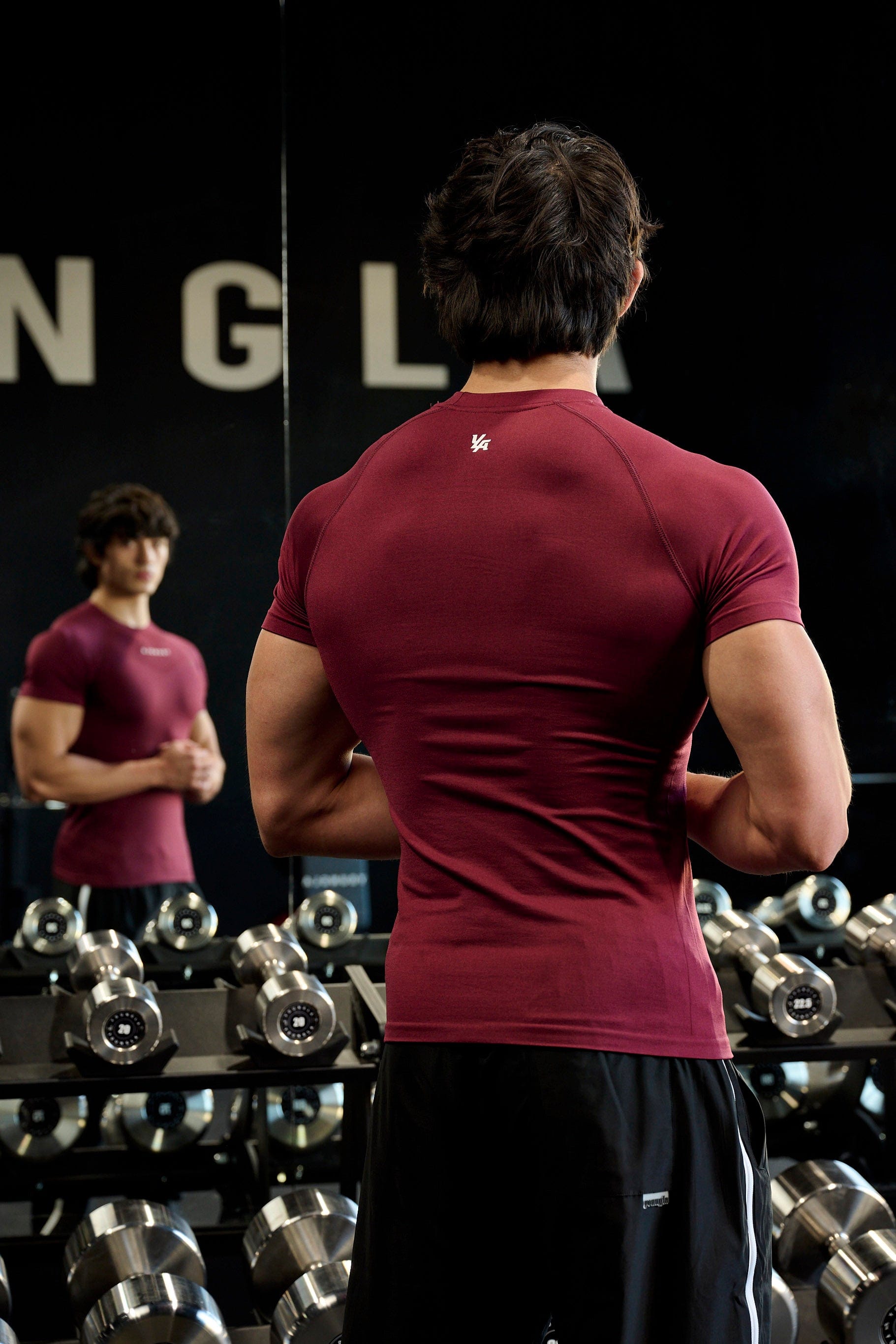 Front view of SuperVillain compression shirt on a man lifting weights.