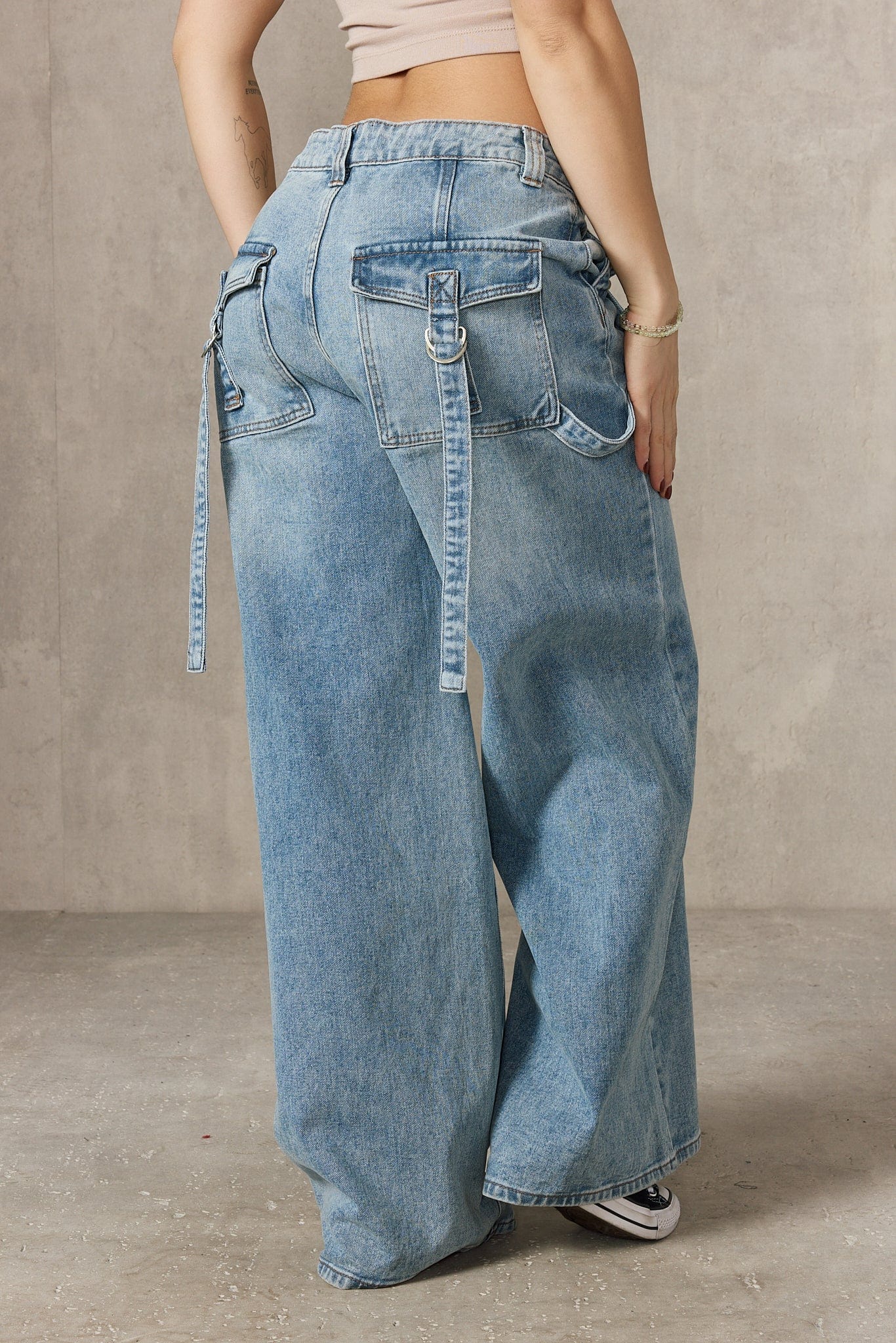 Side angle of the impact jeans showcasing the unique buckle design.