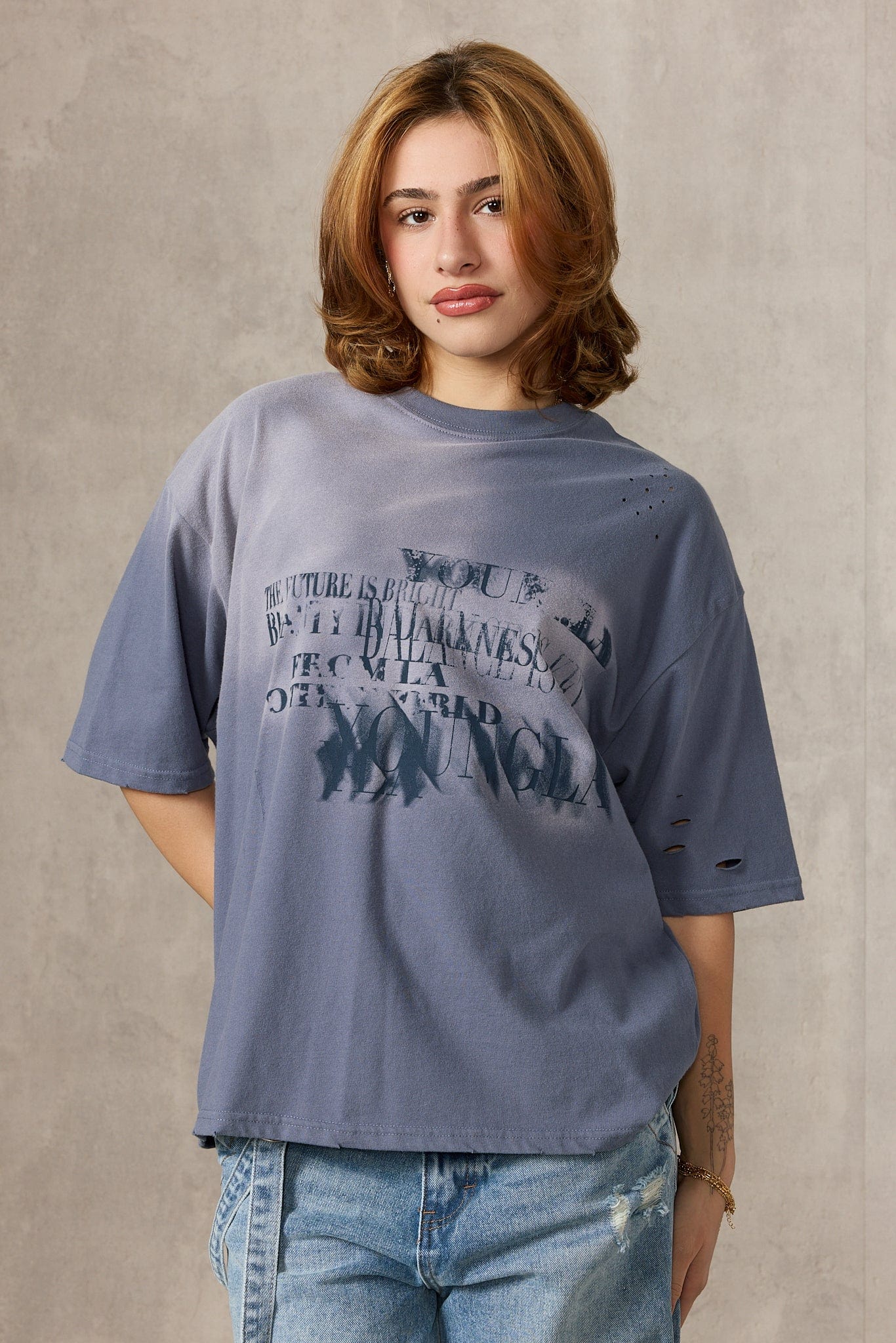 Close-up of illusion graphic print on oversized black tee