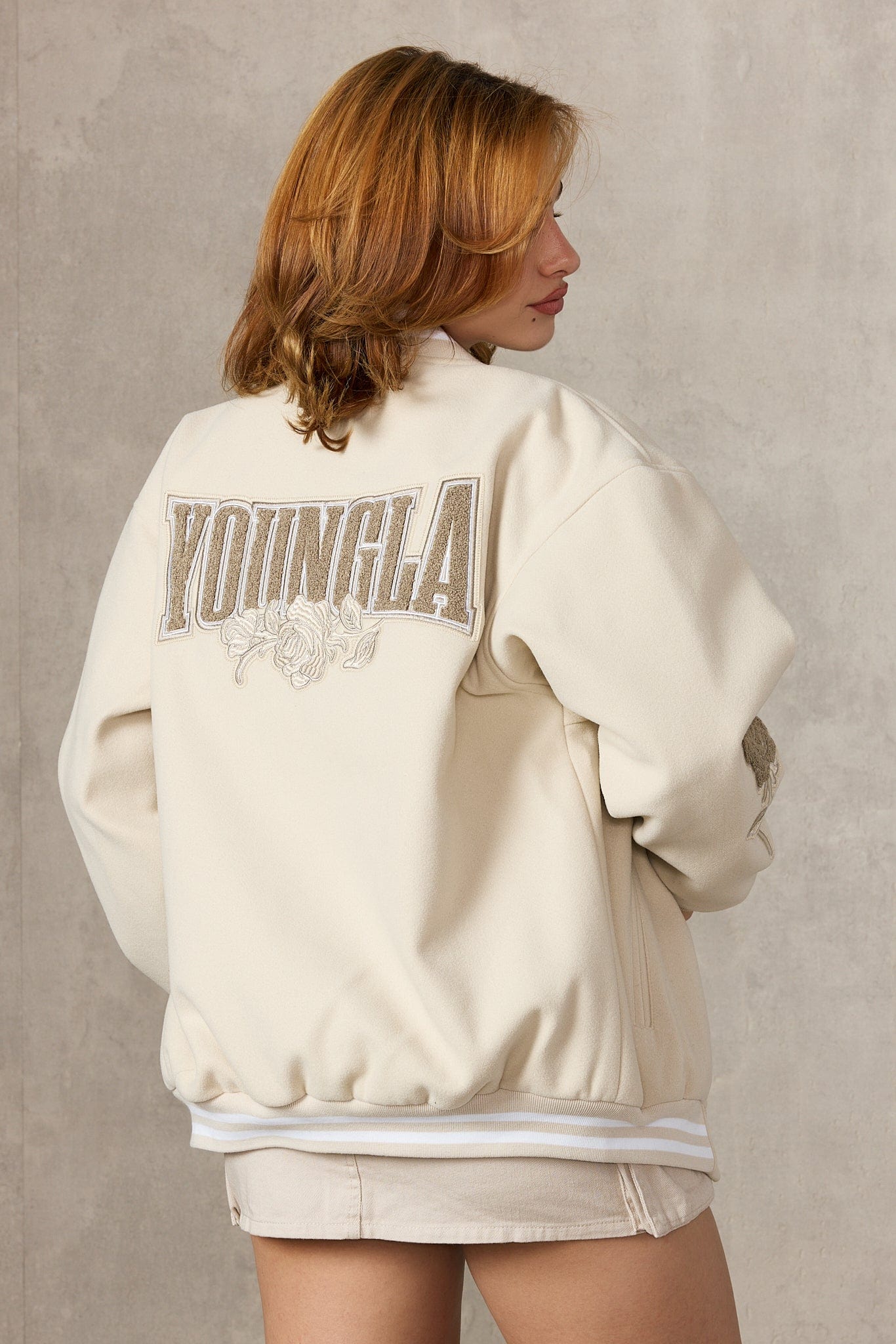 Front view of oversized Ivy League jacket styled with denim jeans