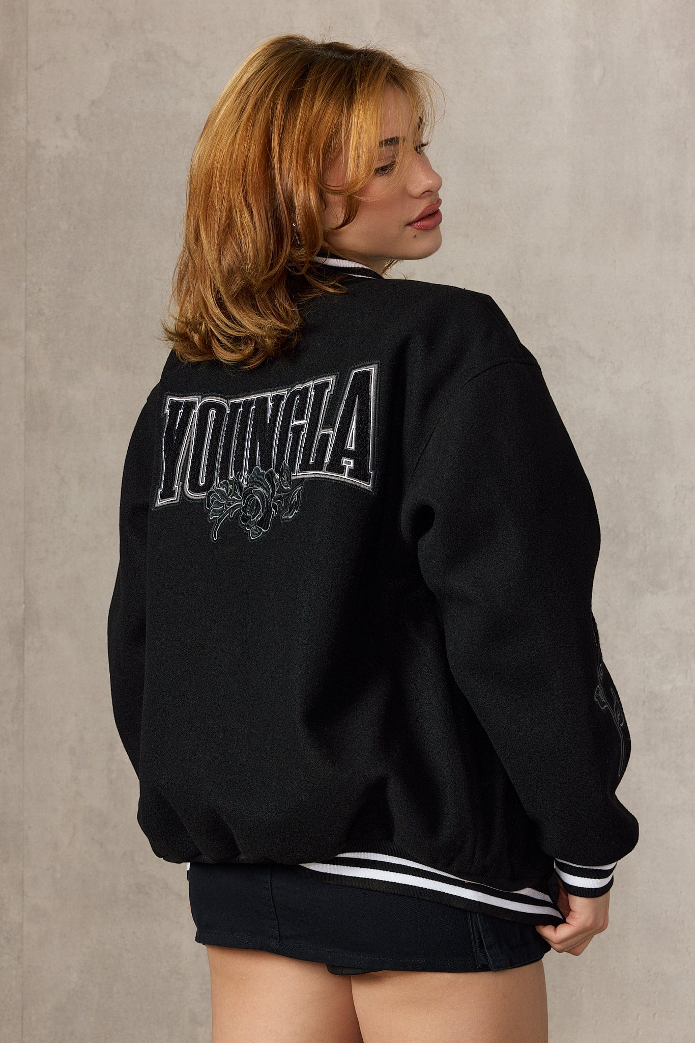 Front view of oversized Ivy League jacket styled with denim jeans