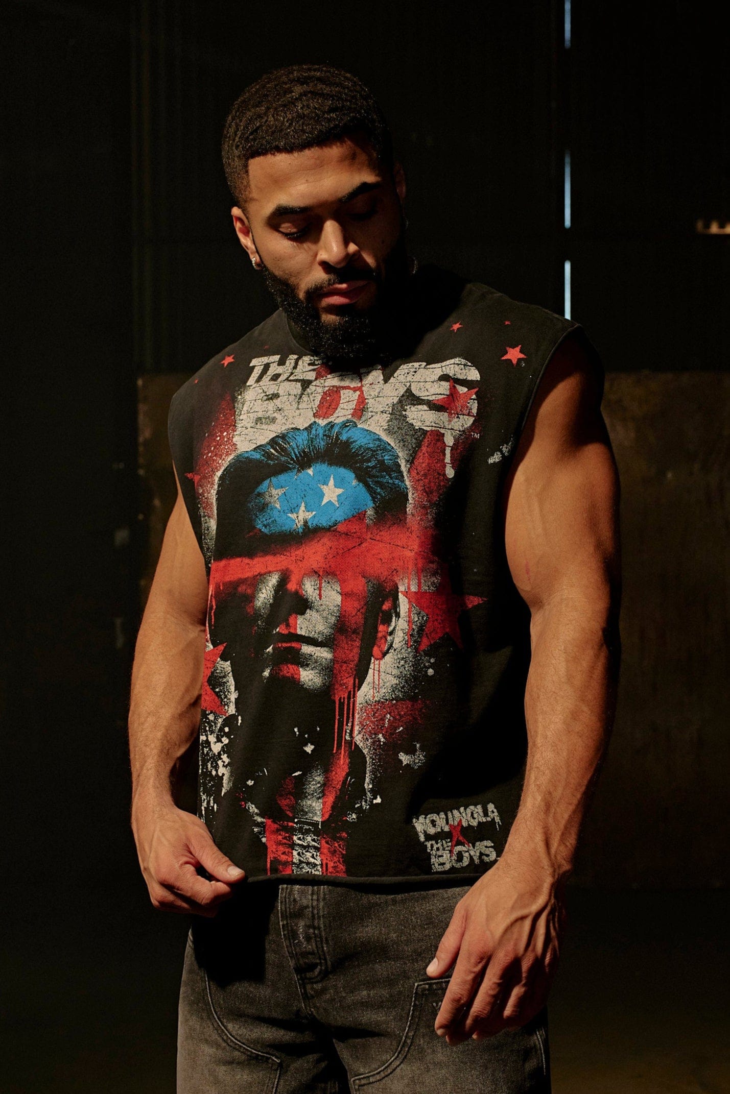 Model wearing The Boys cut-off shorts in urban streetwear style