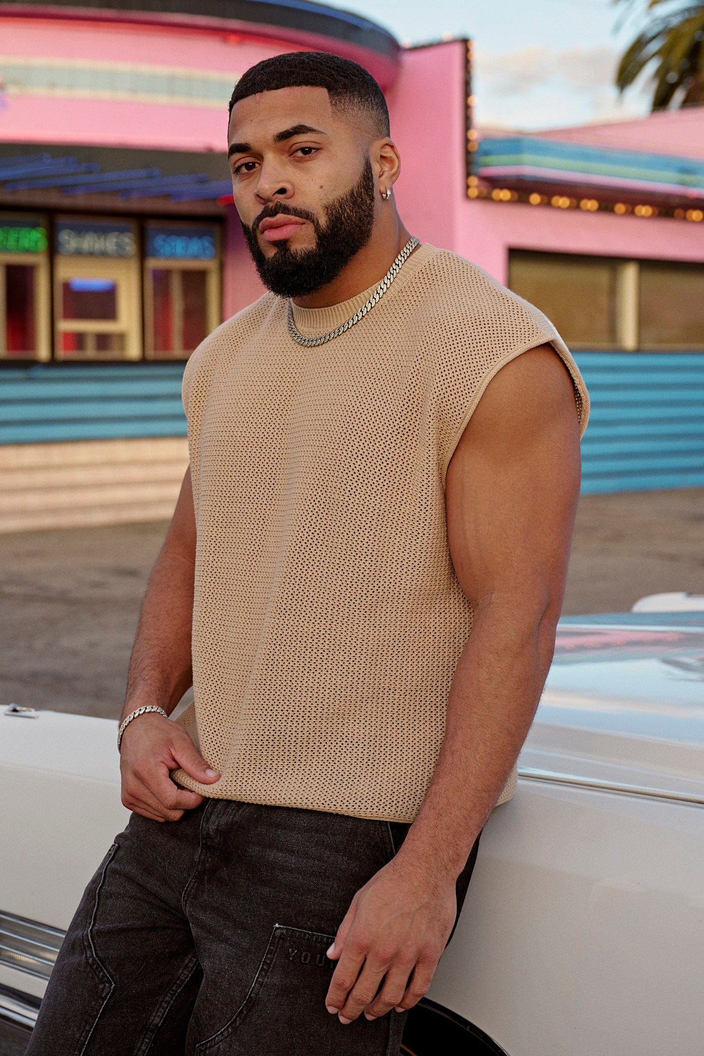 Model wearing the cropped knit tank top outdoors, perfect for summer days