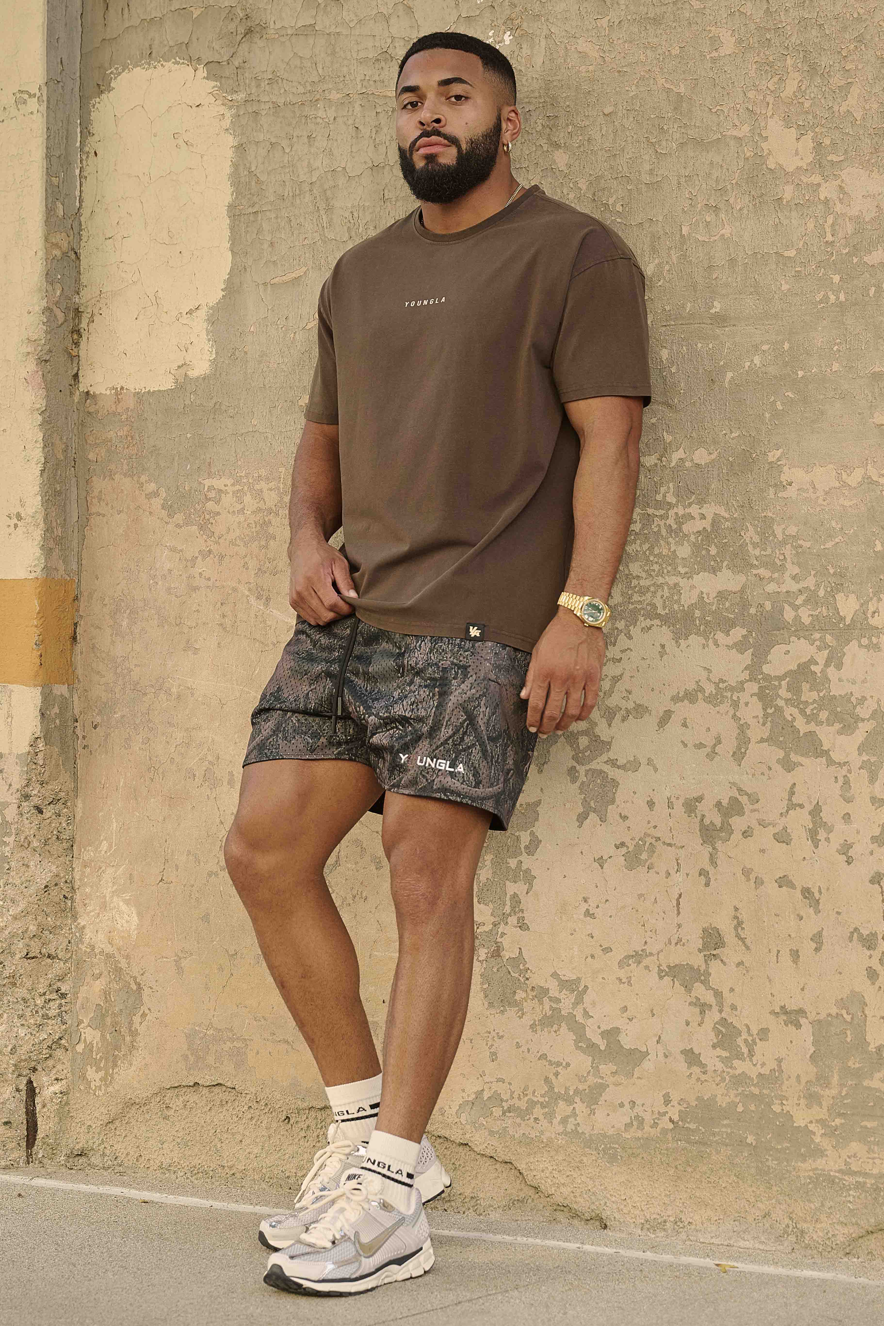 Athletic build wearing these camo cargo shorts during a workout session