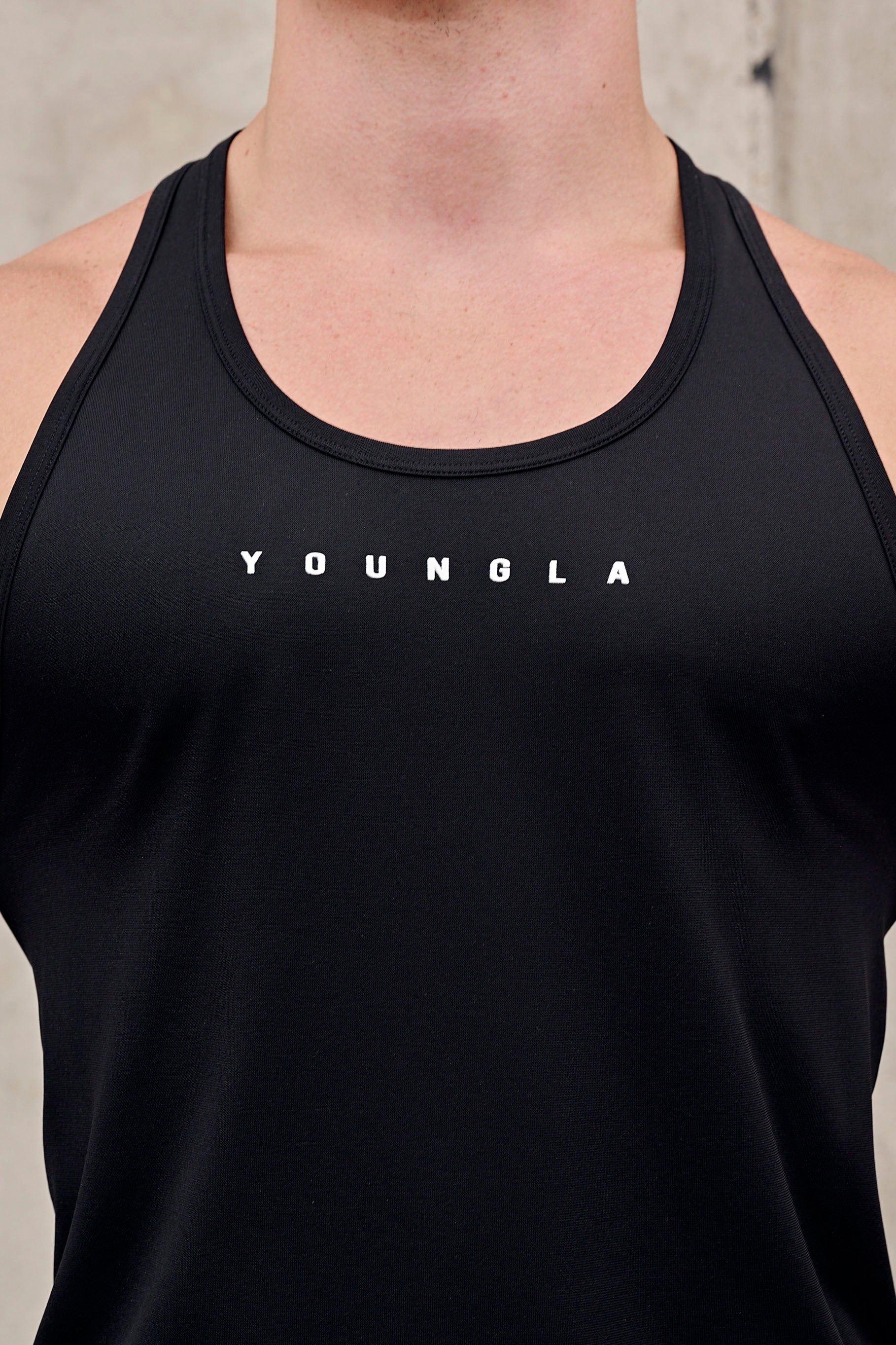 Close-up of 336 Flex Fit muscle tank top on male model during workout