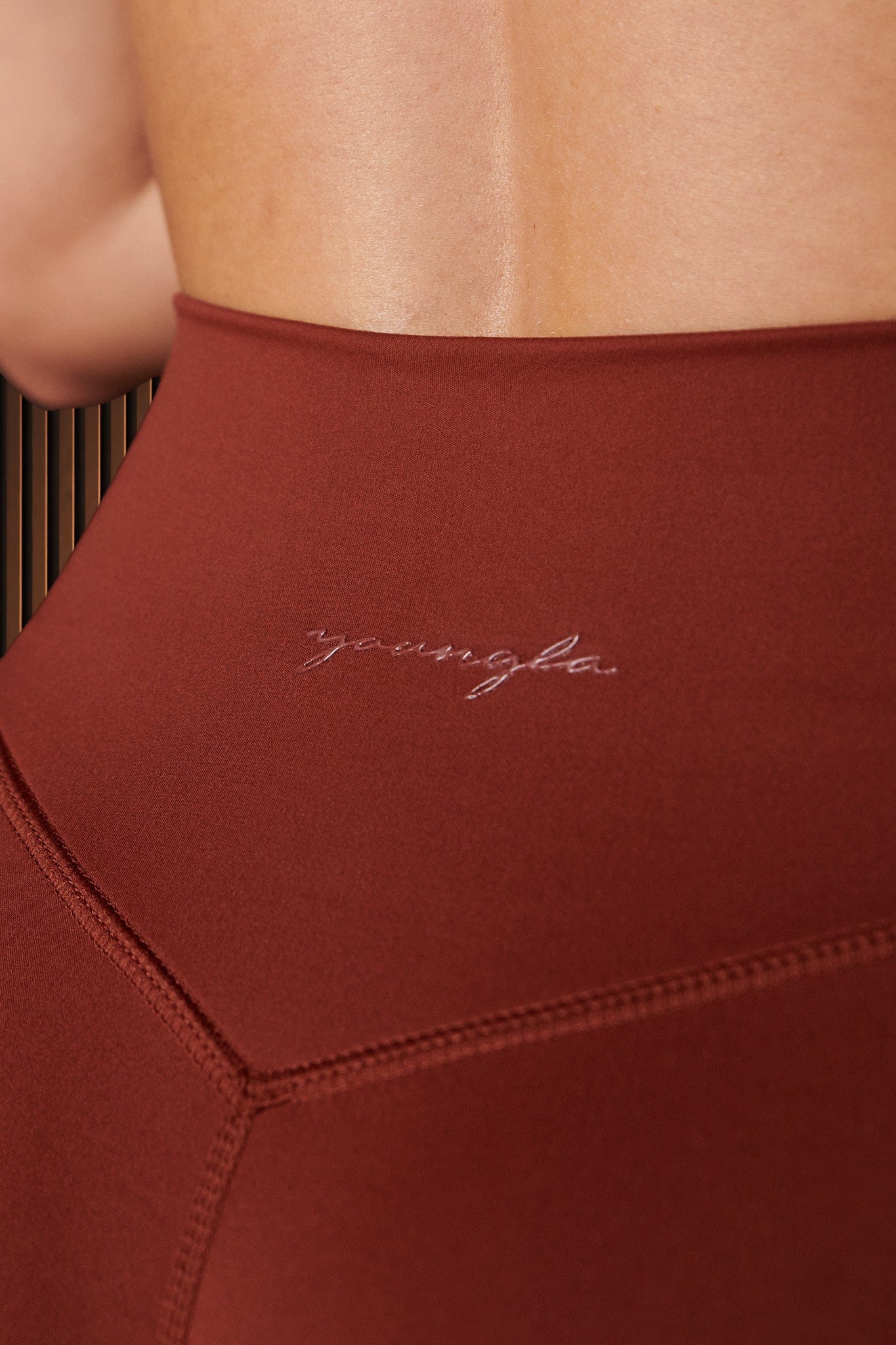 Close-up of high-waist grey flare leggings on a model