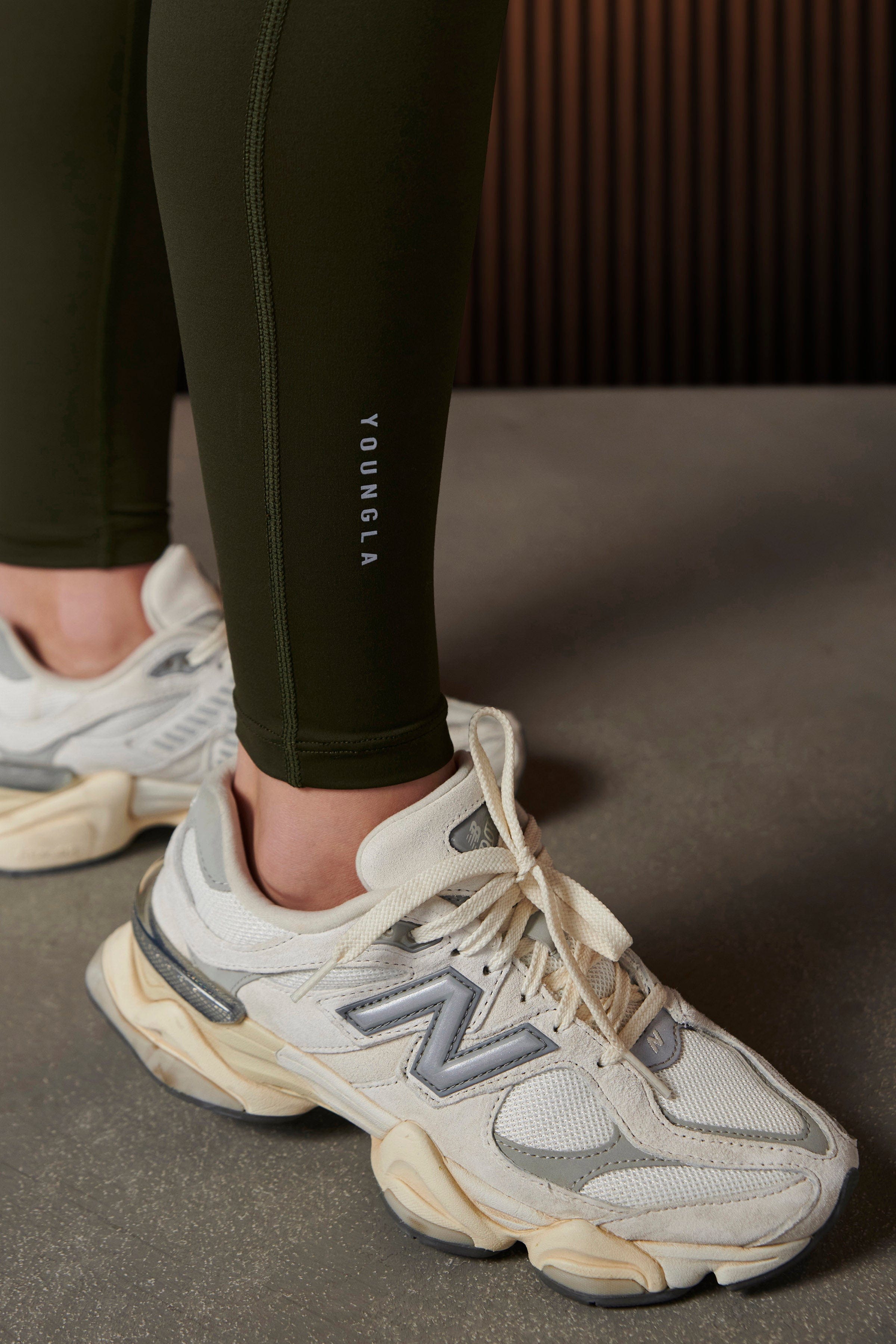 Full-body front view of high rise leggings styled with a cropped workout top
