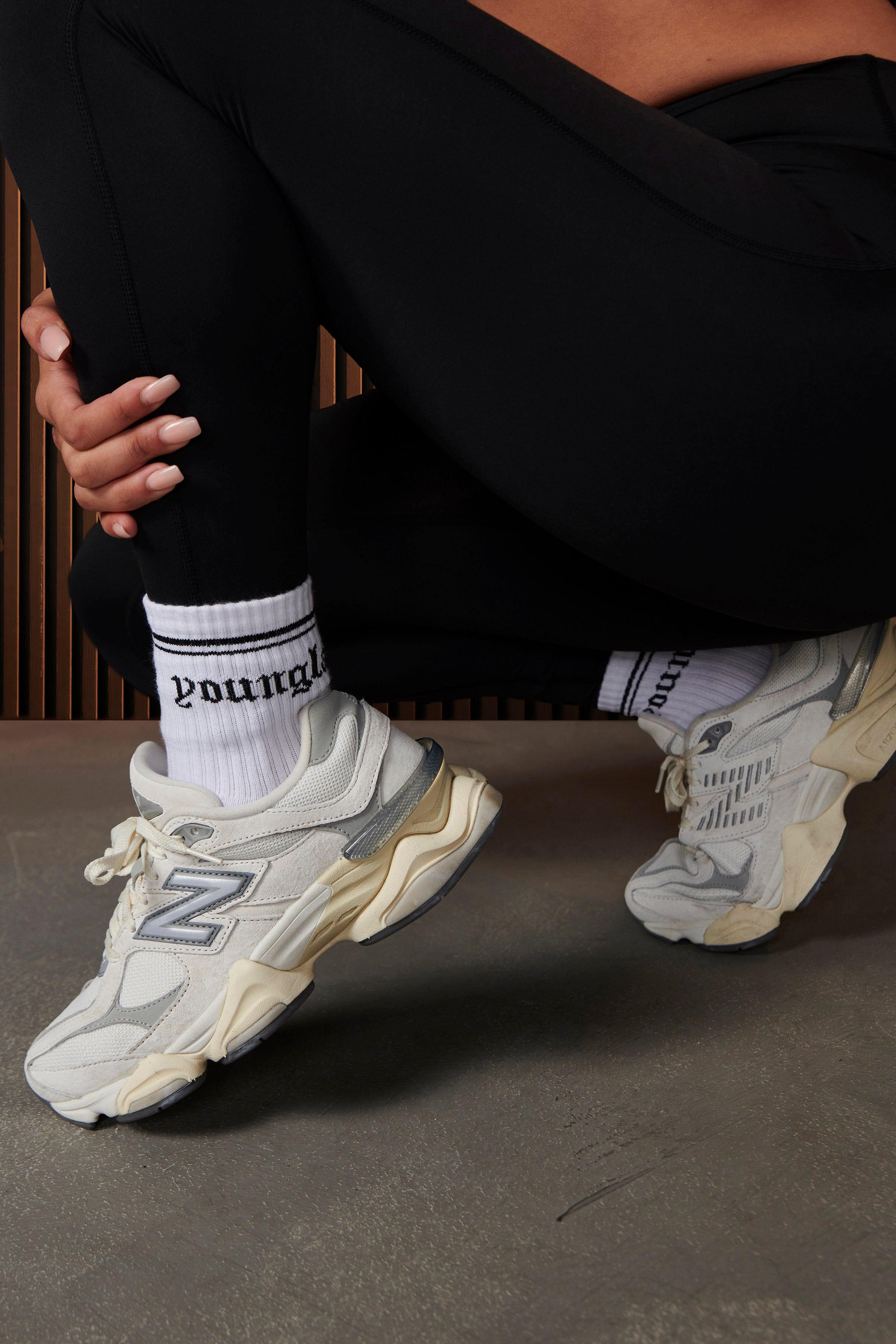 Socks being worn with sneakers for a casual urban look