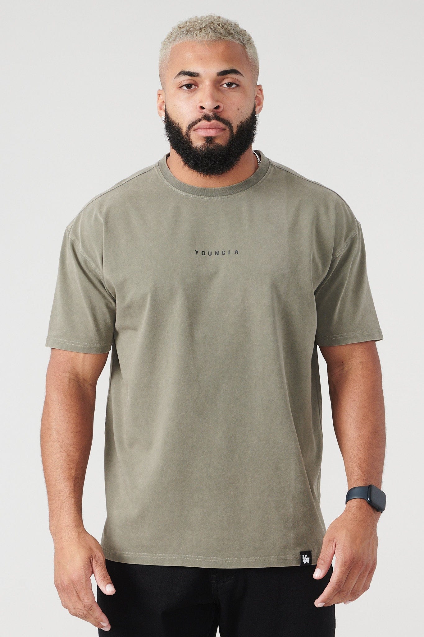 Side view of the essential long sleeve tee worn casually at a coffee shop.