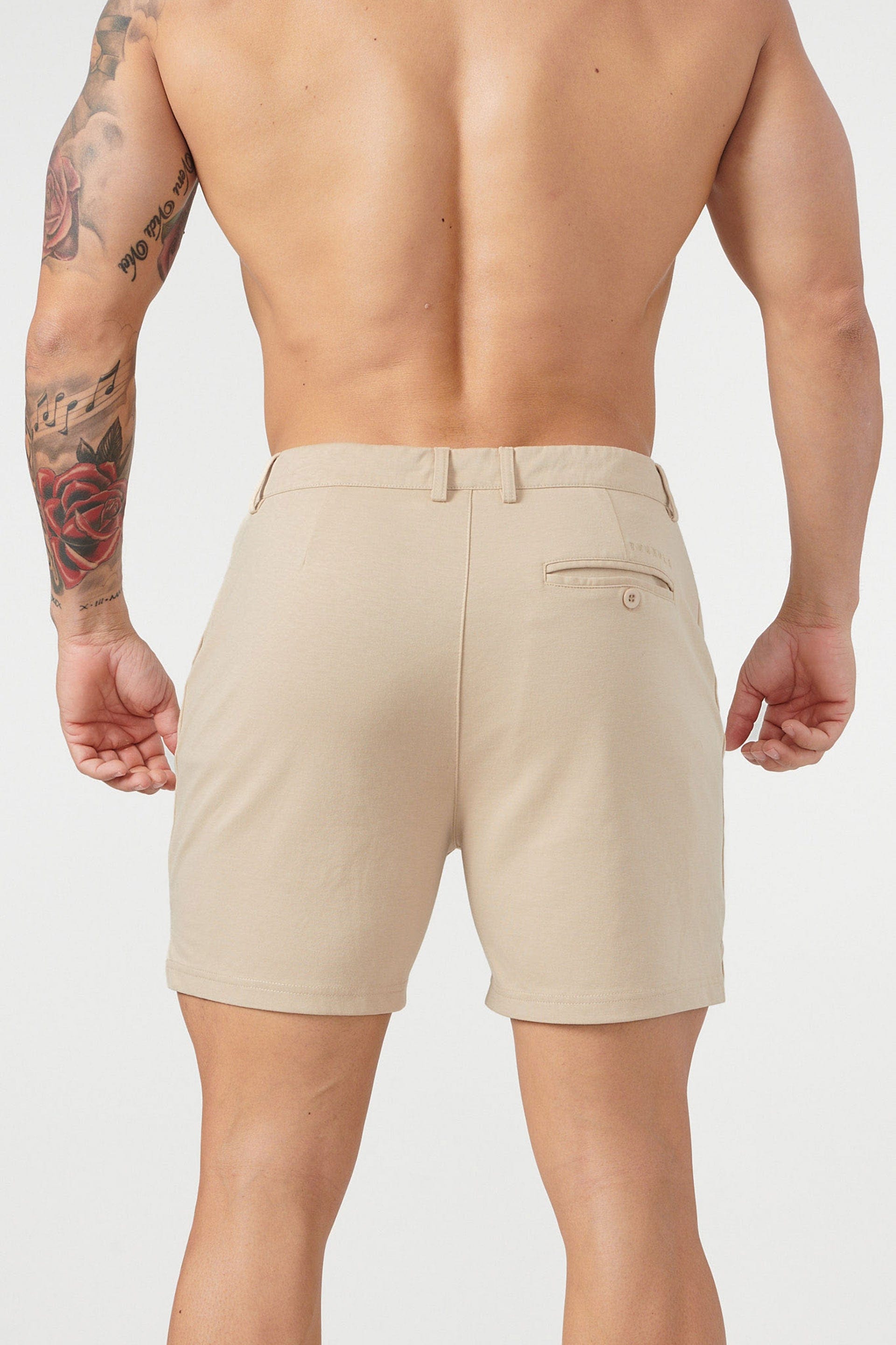 Model wearing khaki chino shorts, ideal for casual summer days.