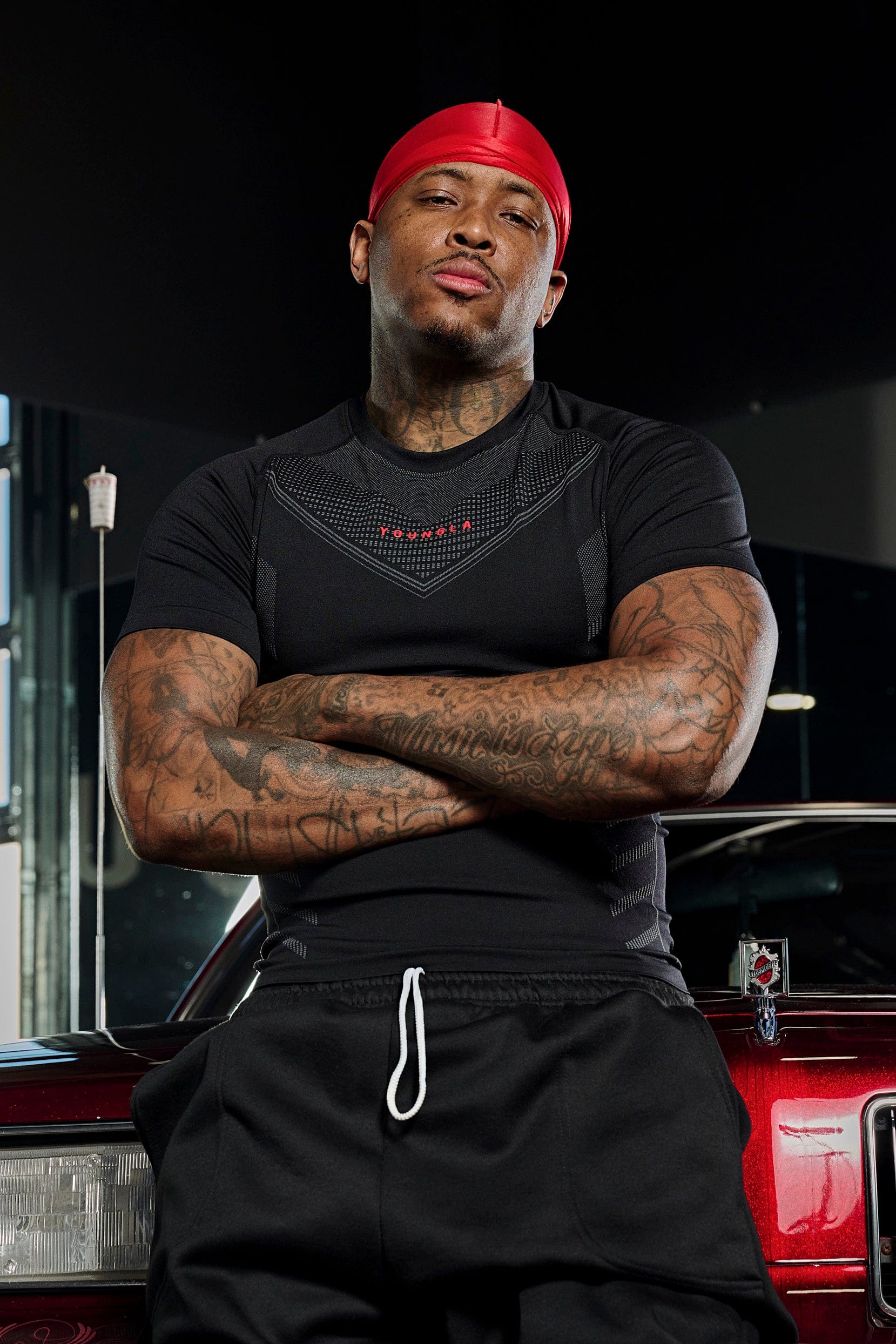 Model wearing the black compression shirt during a workout, highlighting its moisture-wicking feature.